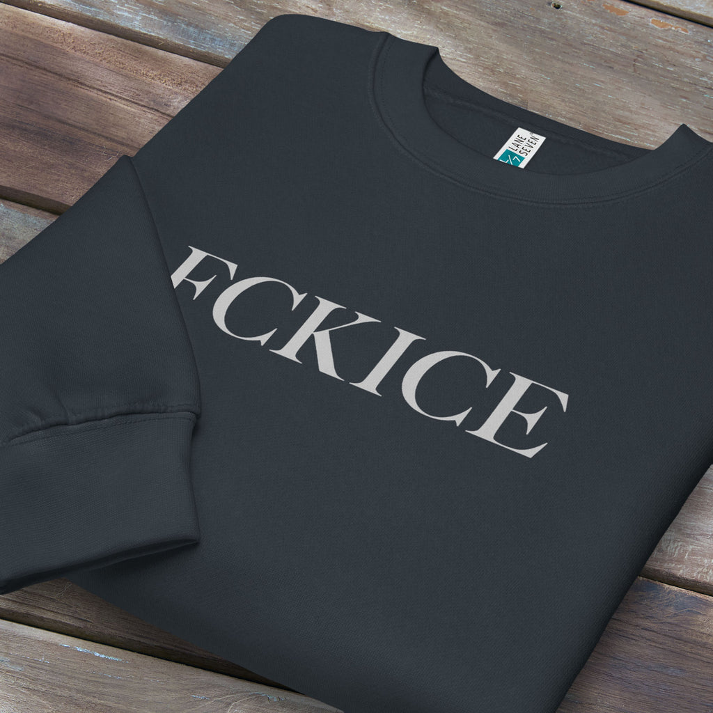 Folded navy sweatshirt with minimalist serif typography reading “FCK ICE,” an anti-ICE political message opposing Immigration and Customs Enforcement abuses and violence.