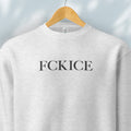 Hanging heather grey sweatshirt with minimalist serif typography reading “FCK ICE,” an anti-ICE political message opposing Immigration and Customs Enforcement abuses and violence.
