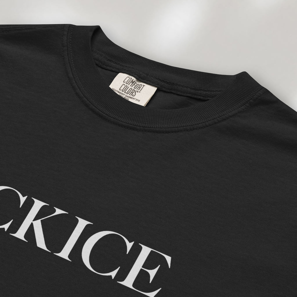 Closeup detail of black t-shirt with minimalist serif typography reading "FCK ICE."