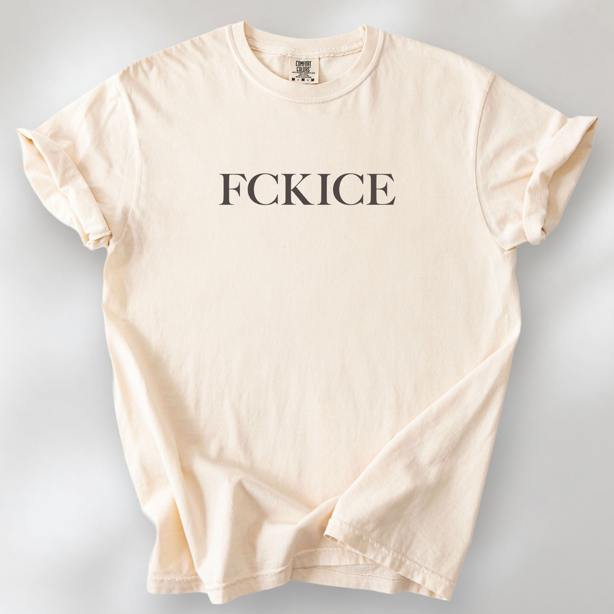 Ivory t-shirt with minimalist serif typography reading "FCK ICE."
