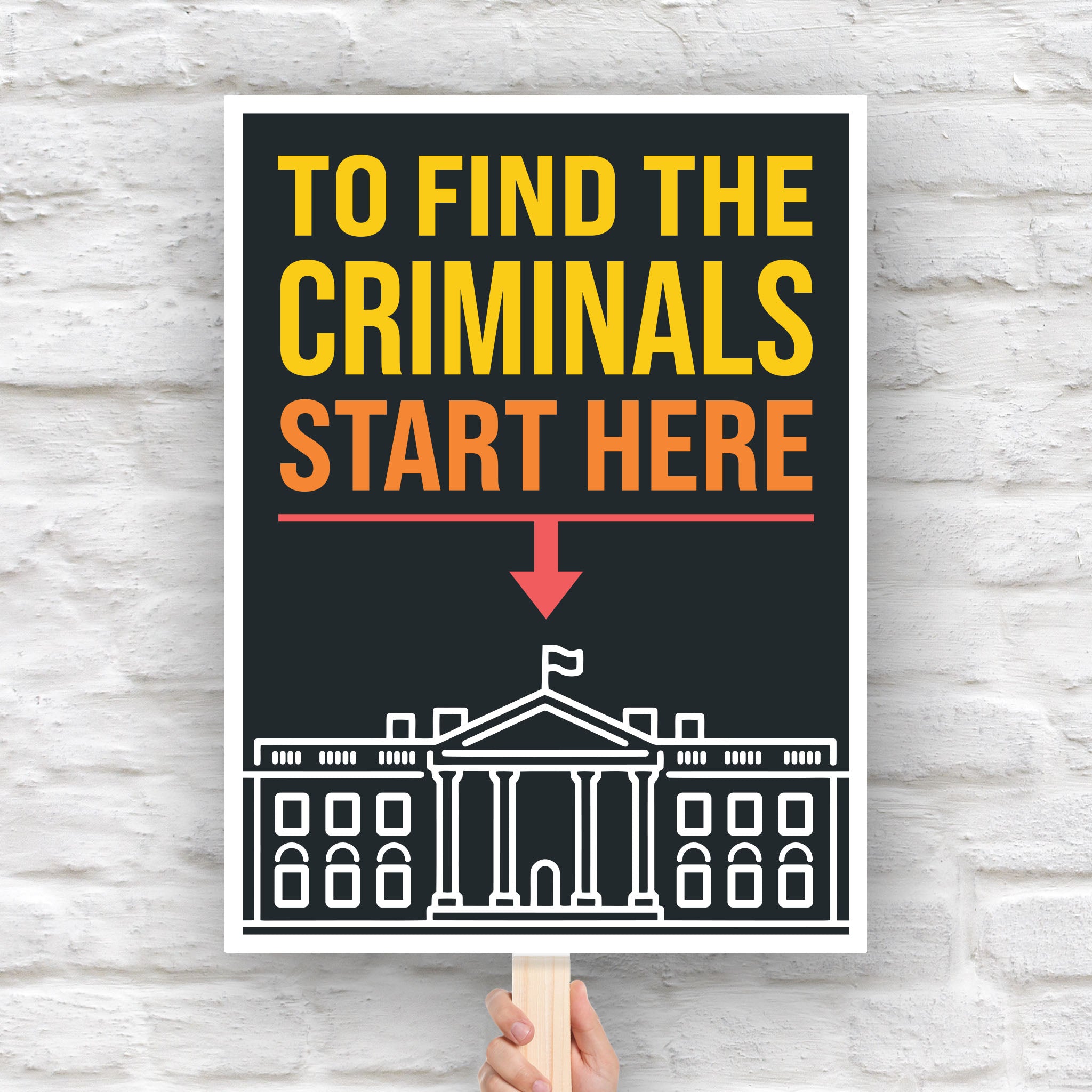 Protest sign with bold text reading "To Find the Criminals Start Here" and an arrow pointing at the White House illustration.