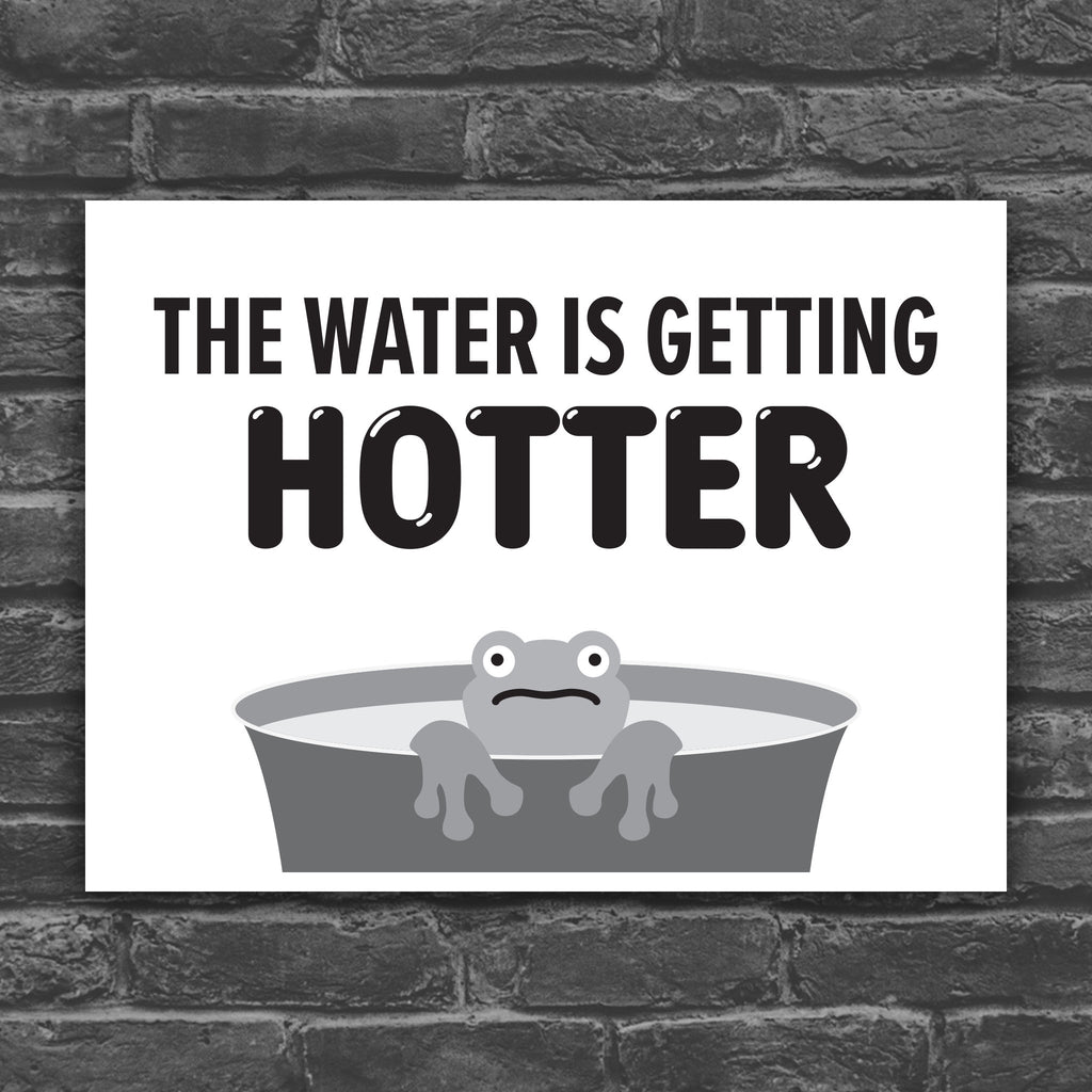 Black and white version of protest sign with bold text that says "The water is getting hotter" above a cartoon illustration of a panicked frog in a pot of water.