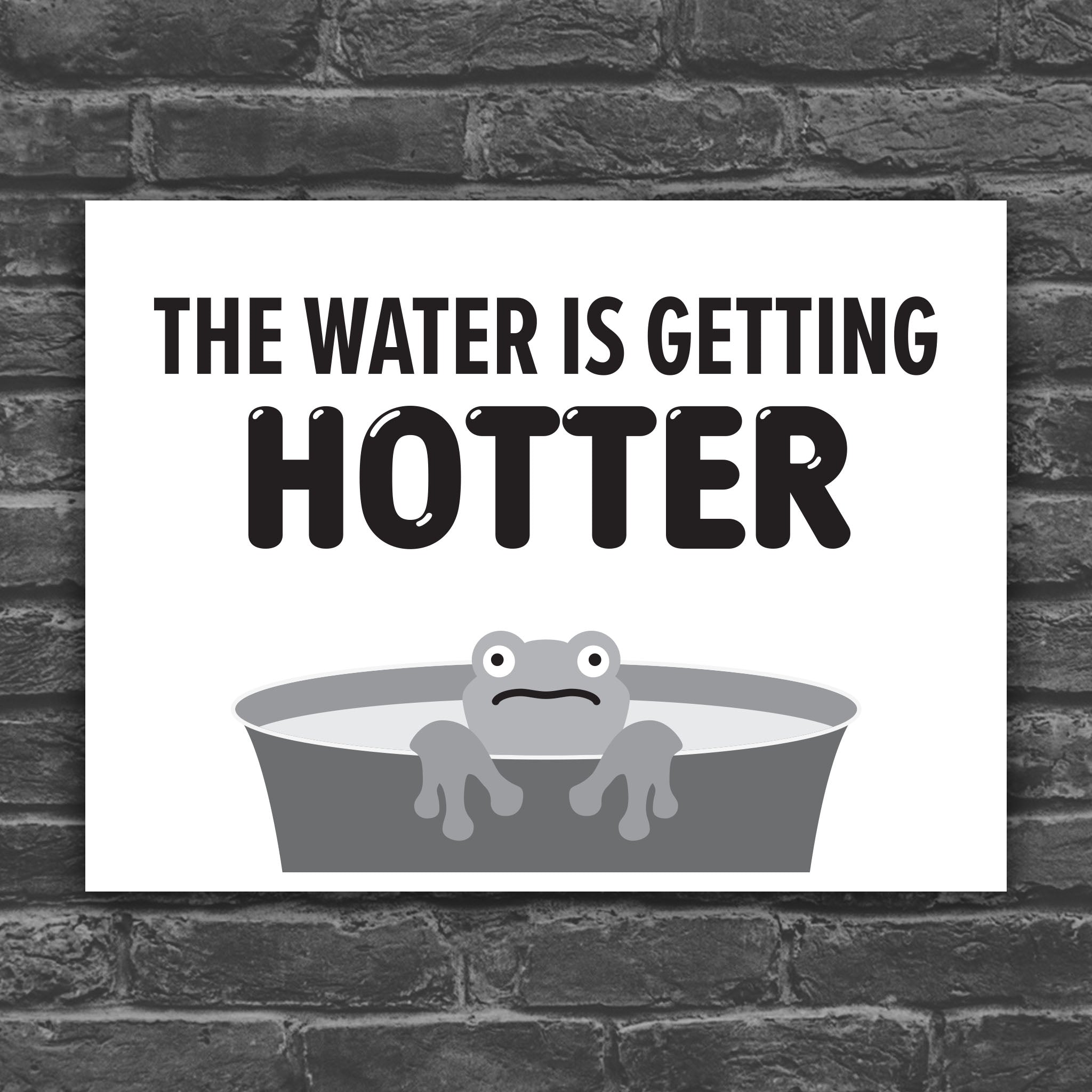 Black and white version of protest sign with bold text that says "The water is getting hotter" above a cartoon illustration of a panicked frog in a pot of water.