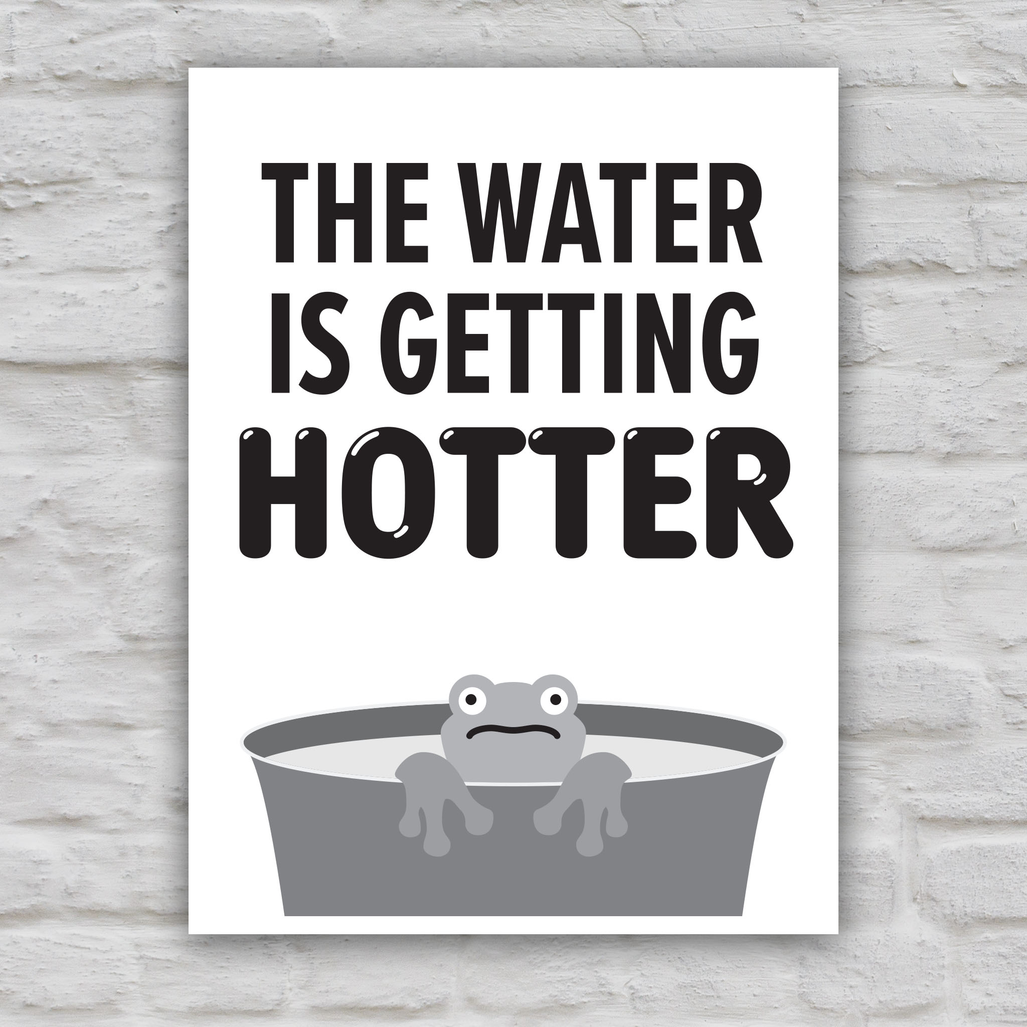 Black and white version of anti-trump protest sign with bold text that says "The water is getting hotter" above a cartoon illustration of a panicked frog in a pot of water.