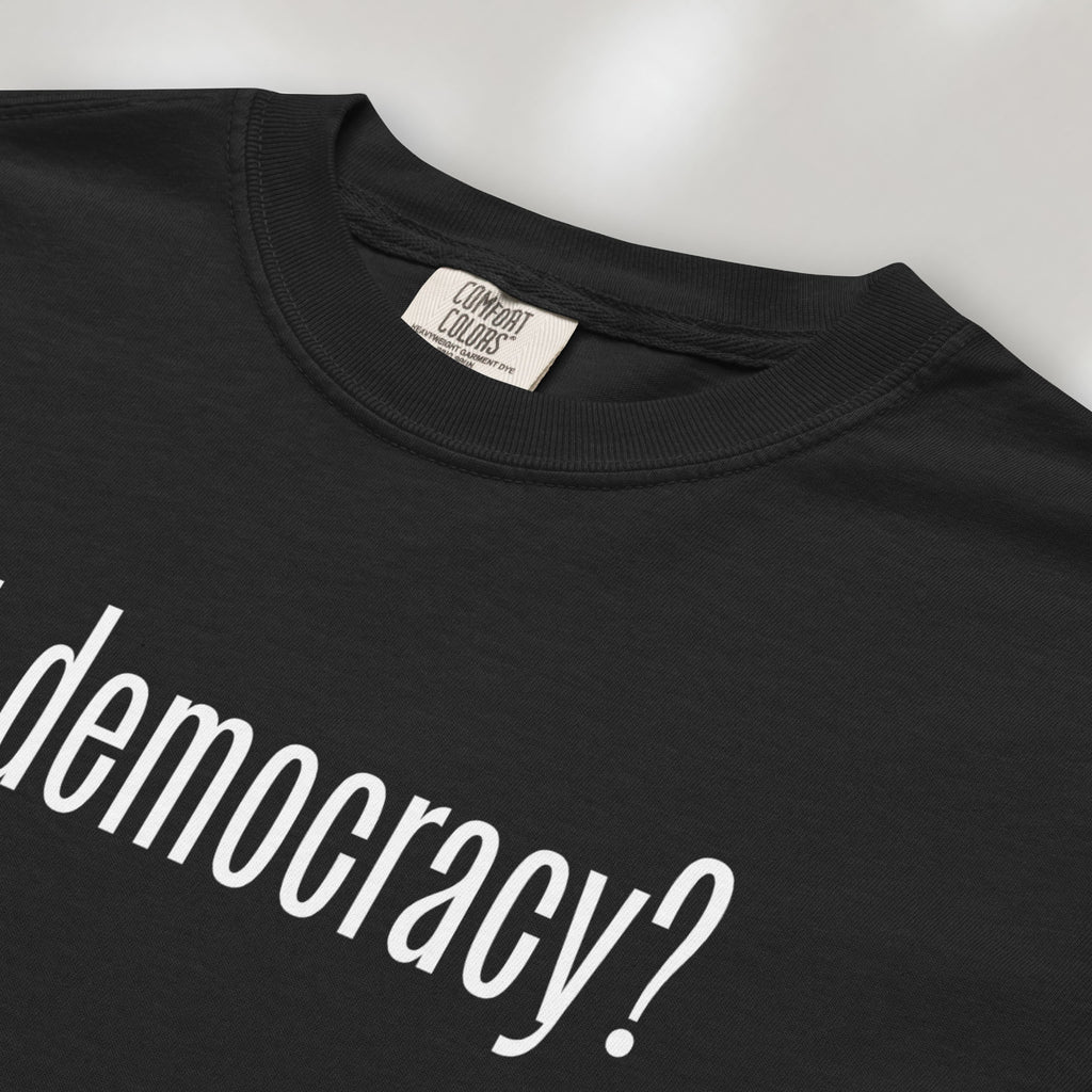 Closeup detail of black t-shirt with white text reading “got democracy?” in minimalist font, styled like the classic “got milk?” design. 