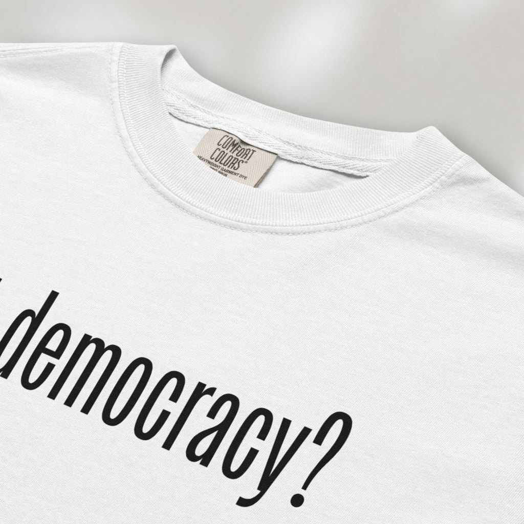 Closeup detail of white t-shirt with white text reading “got democracy?” in minimalist font, styled like the classic “got milk?” design. 