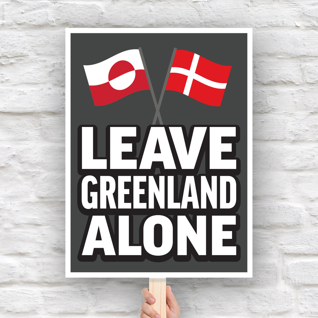 Protest sign reading “Leave Greenland Alone” with Greenland and Denmark flags, opposing Trump’s imperial threats.