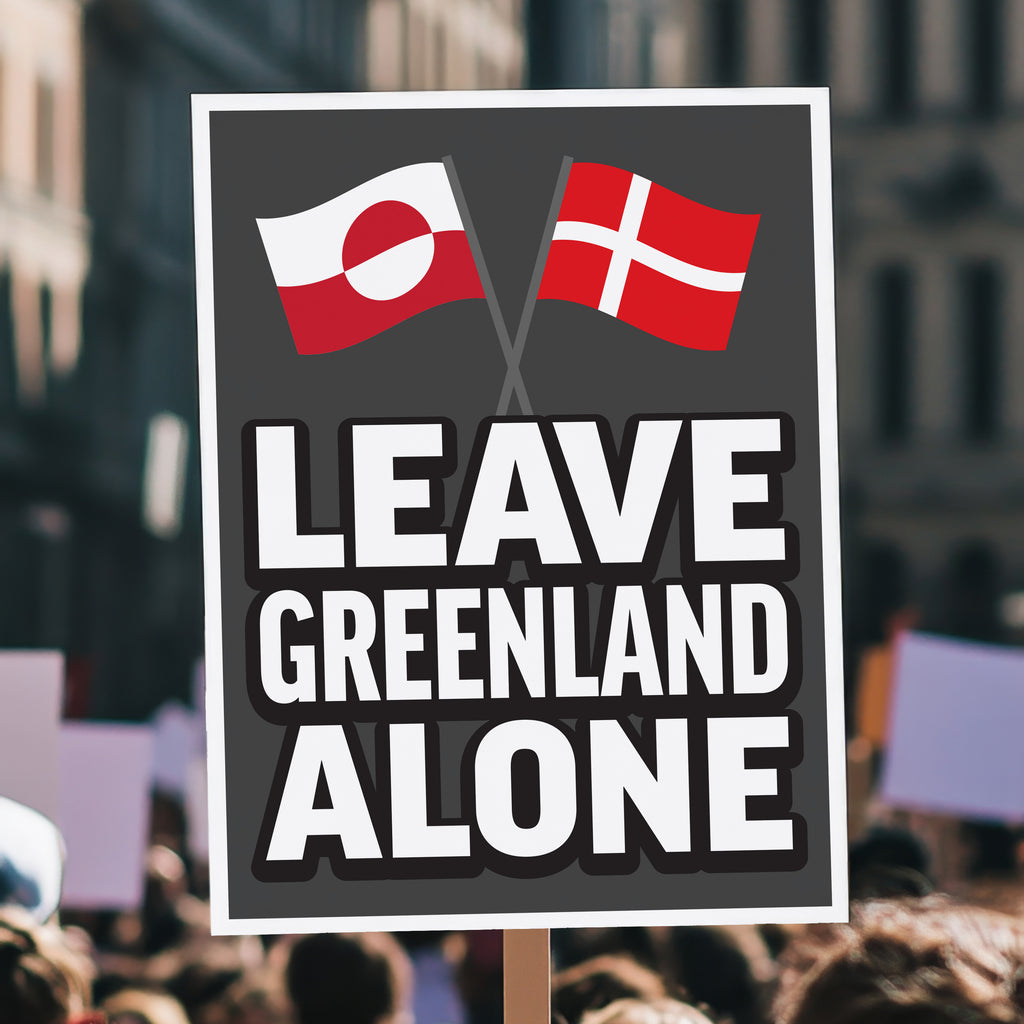Protest sign reading “Leave Greenland Alone” with Greenland and Denmark flags, opposing Trump’s imperial threats, held high above a crowd.
