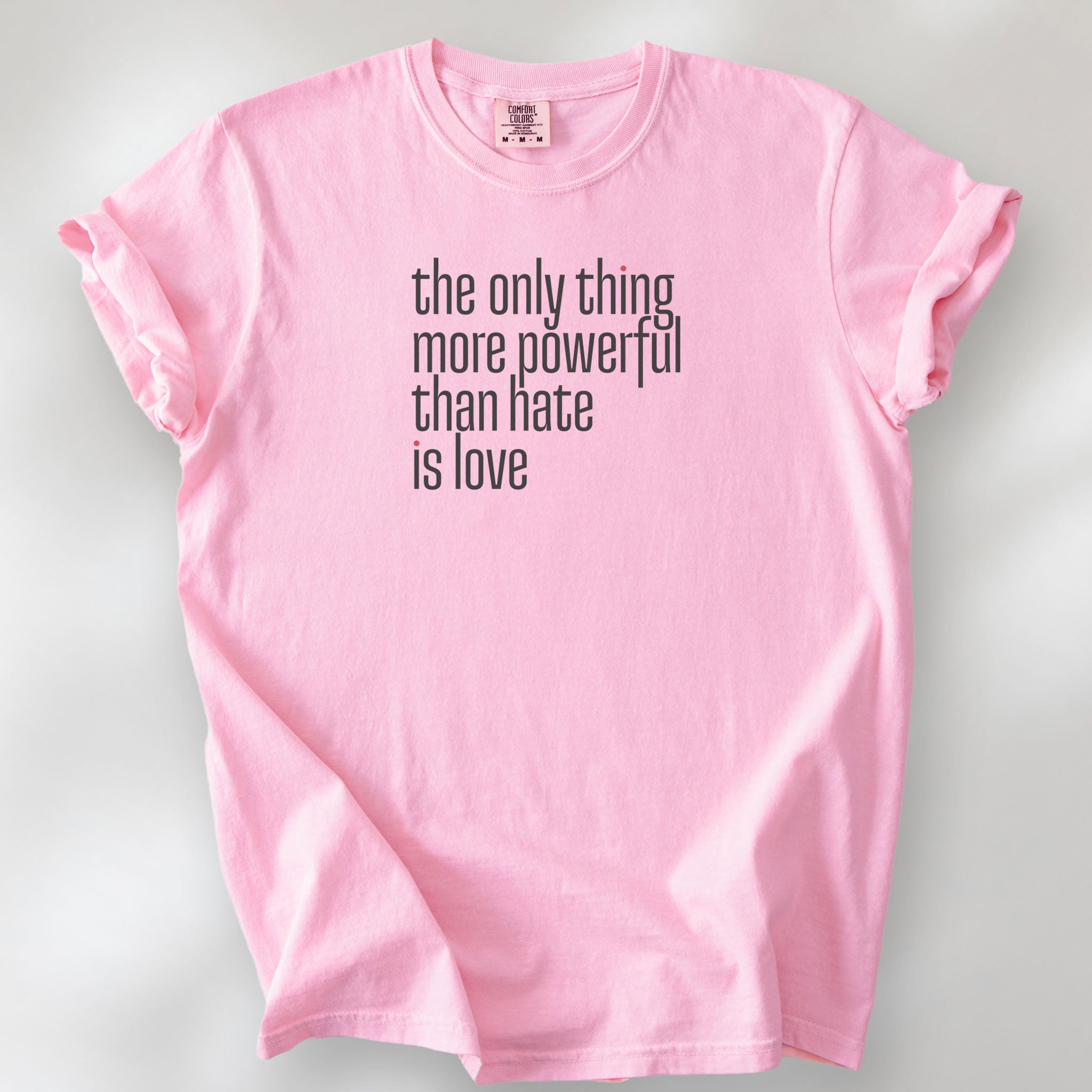 Blossom t-shirt with a stylized text block reading “the only thing more powerful than hate is love."