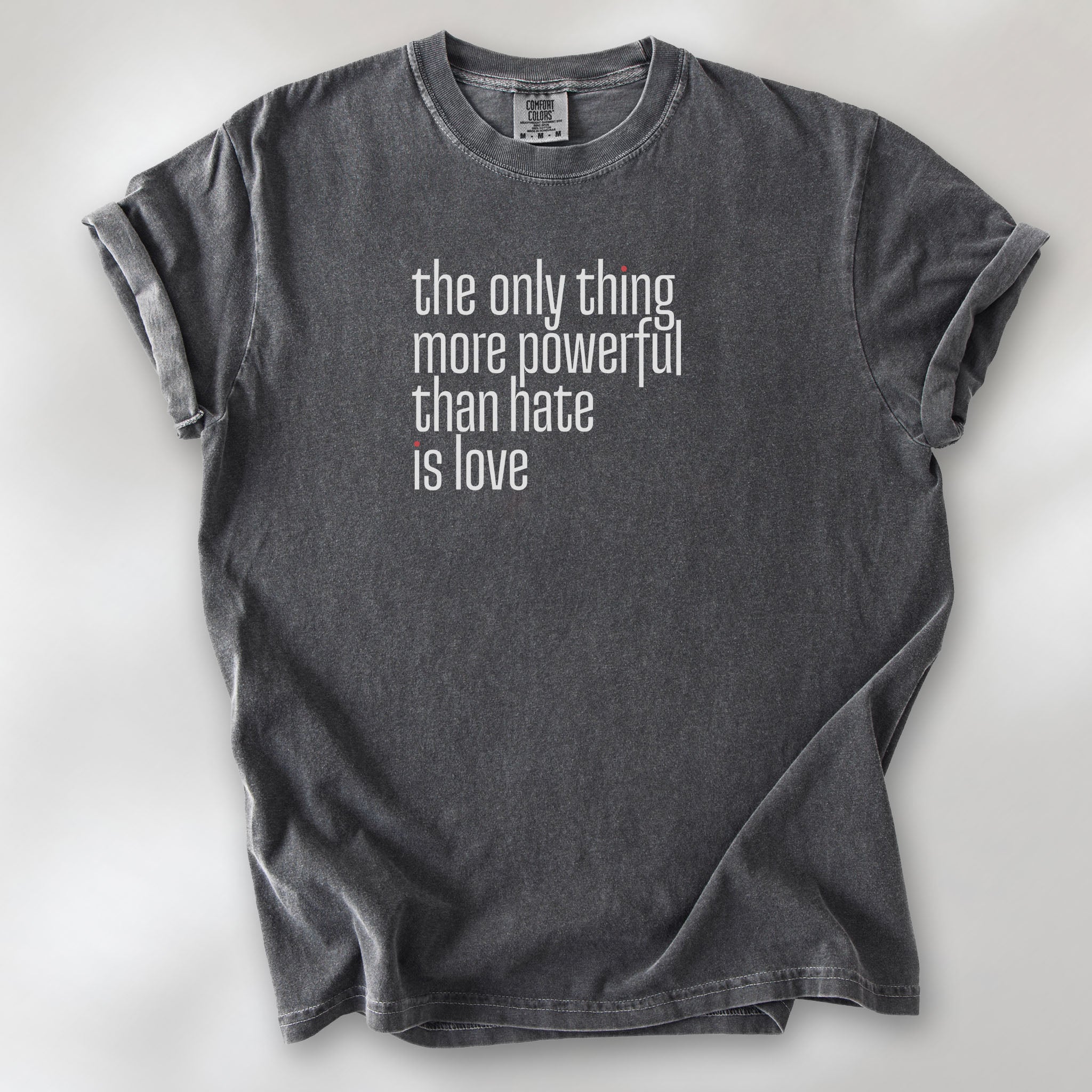 Pepper t-shirt with a stylized text block reading “the only thing more powerful than hate is love."