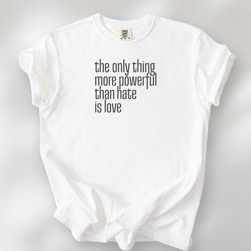 White t-shirt with a stylized text block reading “the only thing more powerful than hate is love."