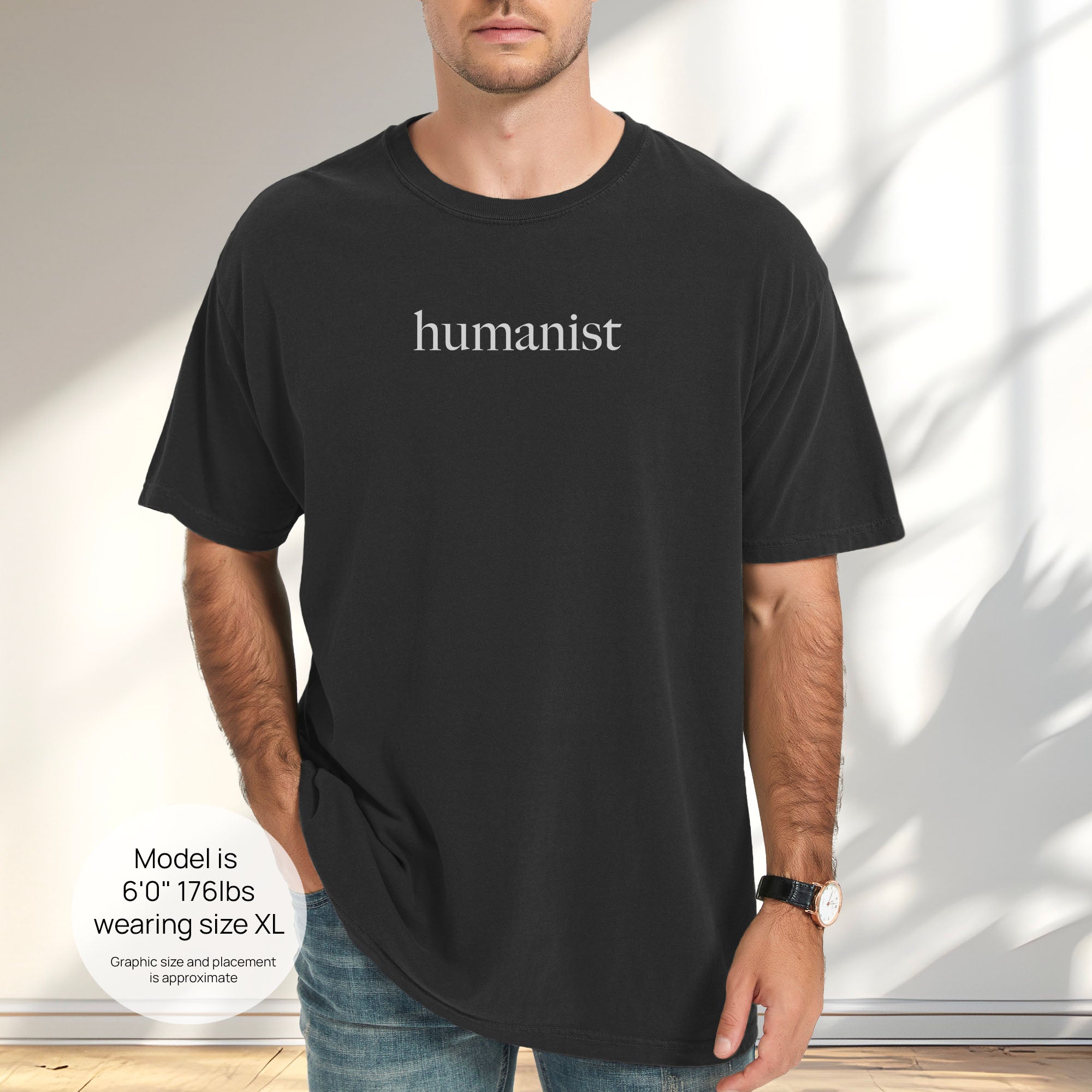 Male model wearing black Comfort Colors t-shirt with minimalist serif text reading “humanist”.