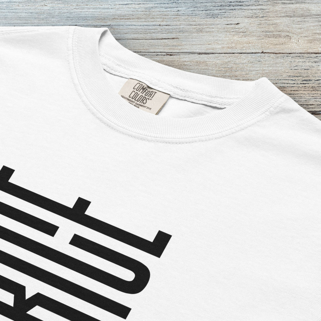 Closeup detail of white t-shirt with minimalist black geometric design that subtly spells “Fuck ICE” using stacked bars and negative space, hidden protest message shirt.