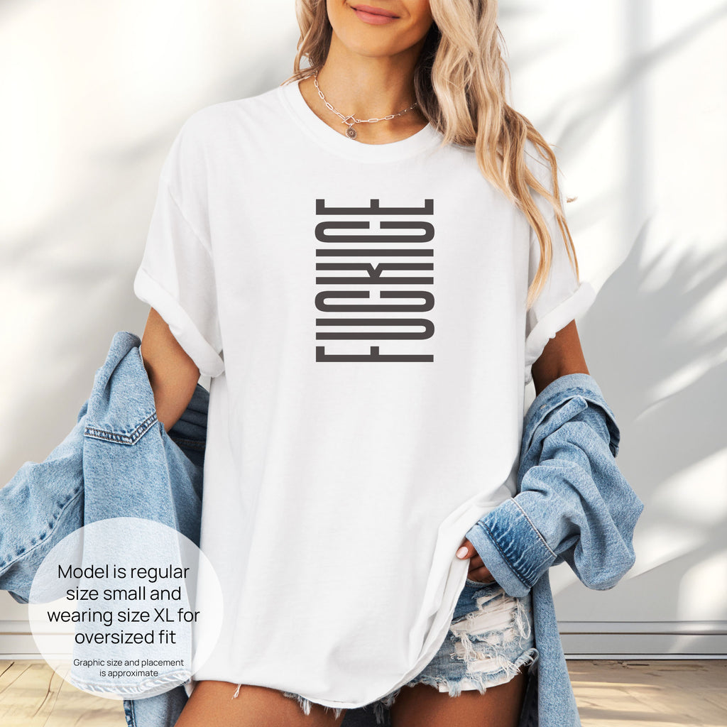Female model wearing oversized white t-shirt with minimalist geometric design that subtly spells “Fuck ICE” using stacked bars and negative space, hidden protest message shirt. Includes size and fit information for the model who is regular size small, and wearing a size XL shirt for an oversized fit.
