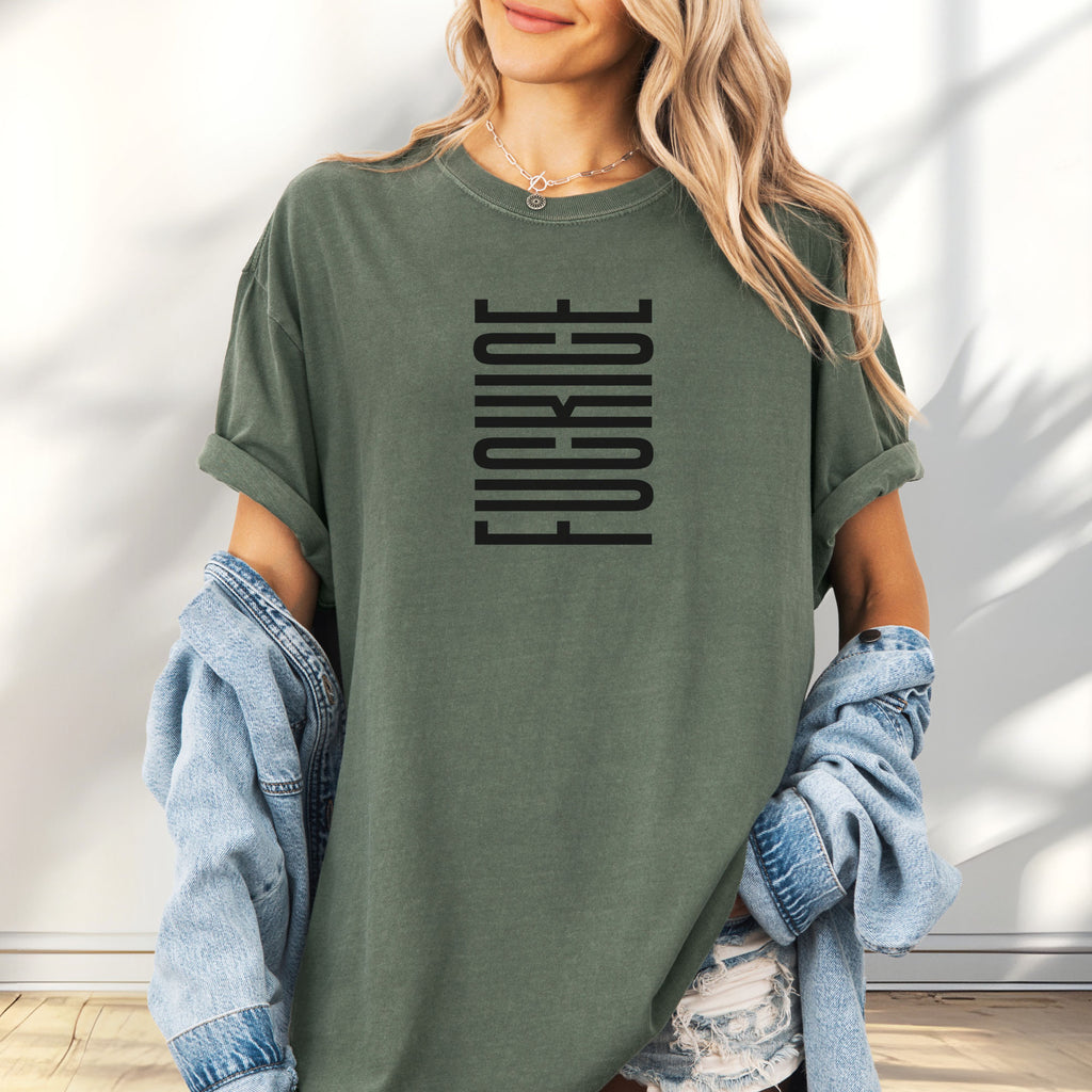 Female model wearing oversized moss t-shirt with minimalist black geometric design that subtly spells “Fuck ICE” using stacked bars and negative space, hidden protest message shirt.