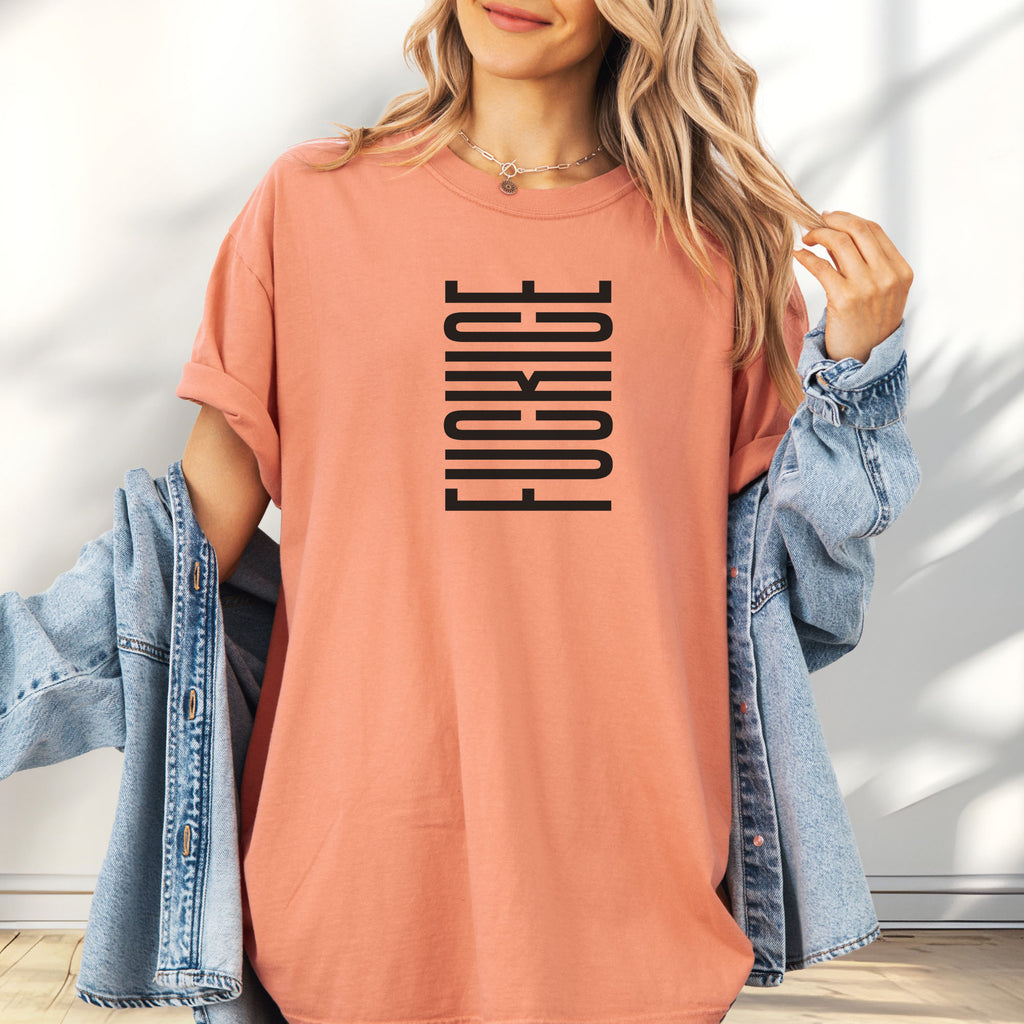 Female model wearing oversized terracotta t-shirt with minimalist black geometric design that subtly spells “Fuck ICE” using stacked bars and negative space, hidden protest message shirt.