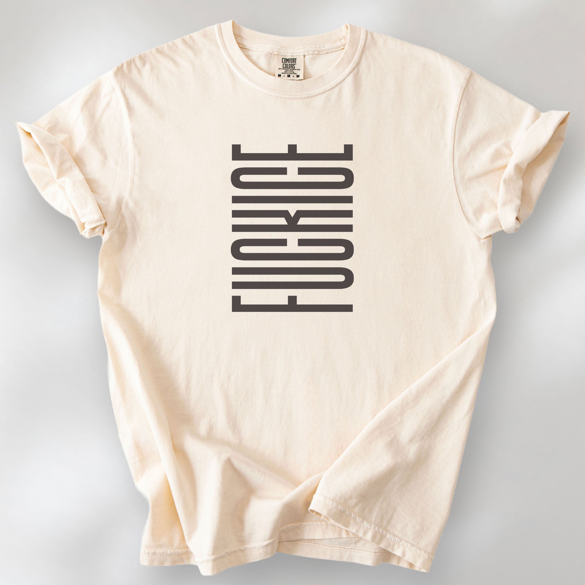 Ivory t-shirt with minimalist geometric design that subtly spells “Fuck ICE” using stacked bars and negative space, hidden protest message shirt.