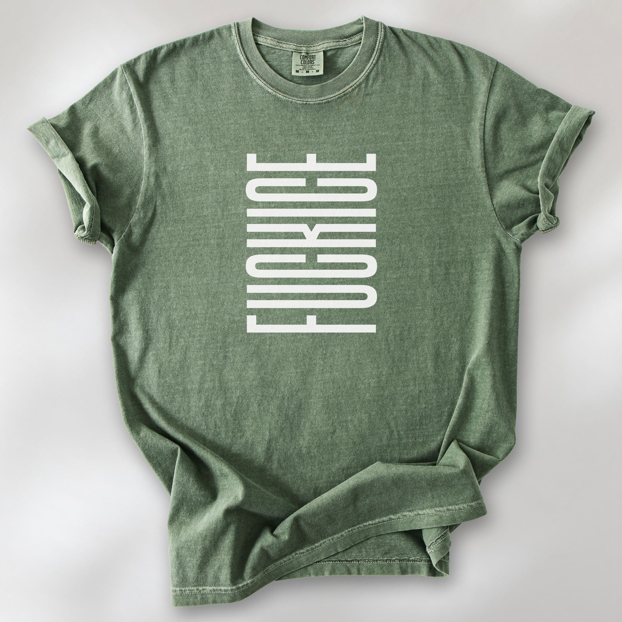 Moss t-shirt with minimalist geometric design that subtly spells “Fuck ICE” using stacked bars and negative space, hidden protest message shirt.