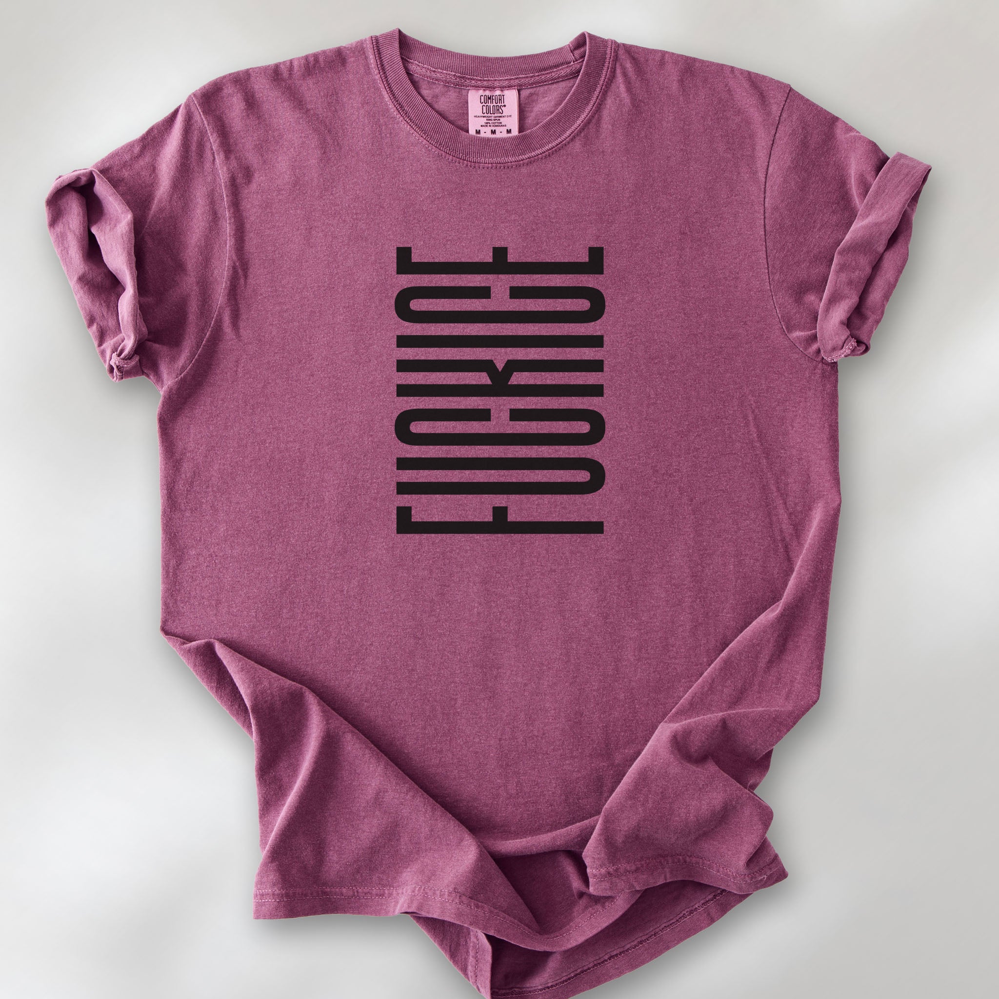 Berry t-shirt with minimalist black geometric design that subtly spells “Fuck ICE” using stacked bars and negative space, hidden protest message shirt.