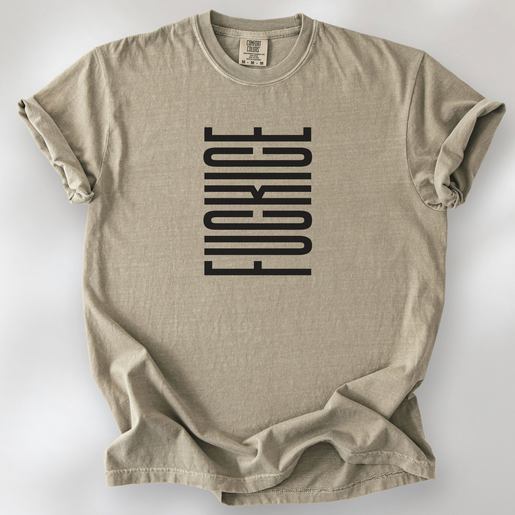 Khaki t-shirt with minimalist black geometric design that subtly spells “Fuck ICE” using stacked bars and negative space, hidden protest message shirt.