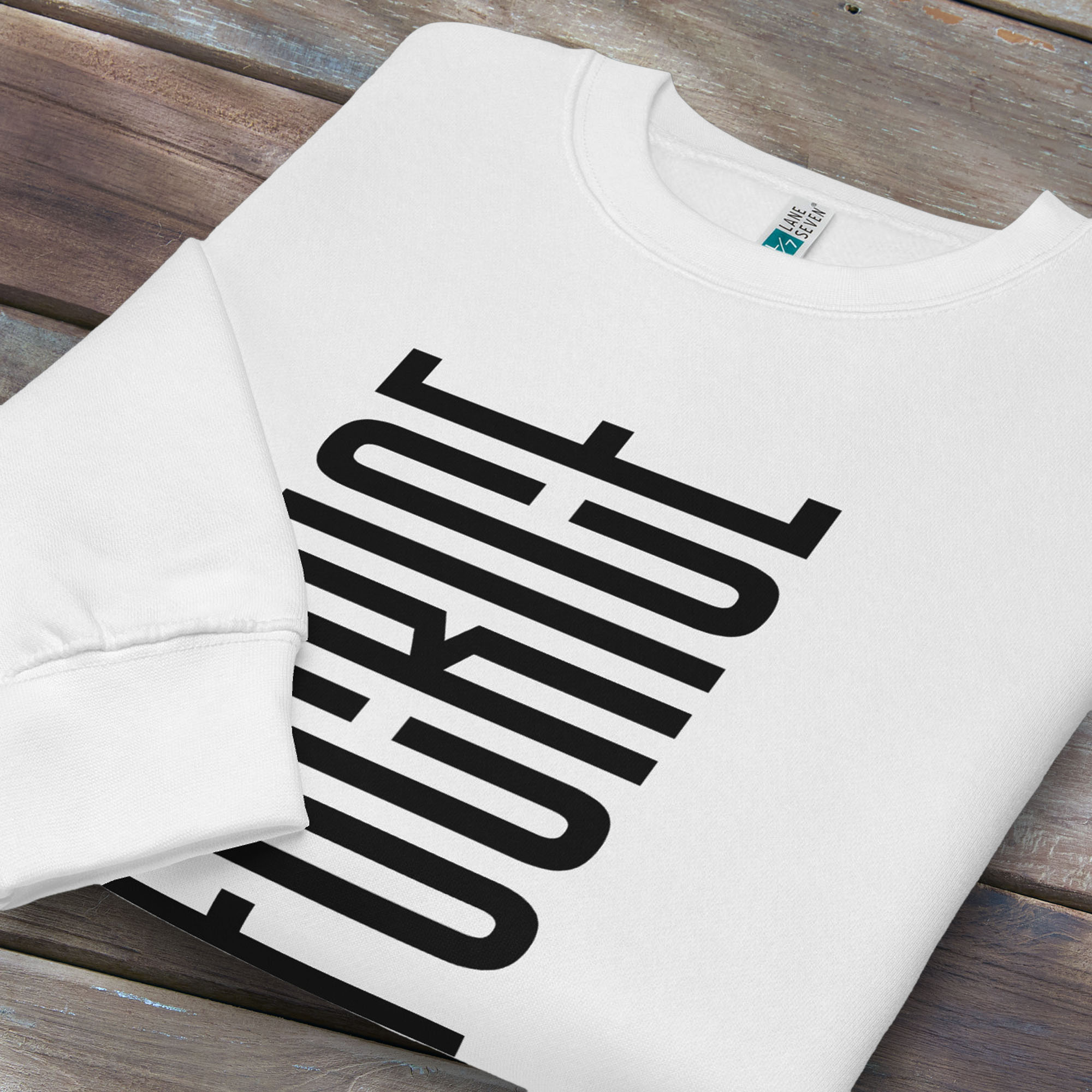 Folded white sweatshirt with minimalist black geometric design that subtly spells “Fuck ICE” using stacked bars and negative space, hidden protest message shirt.