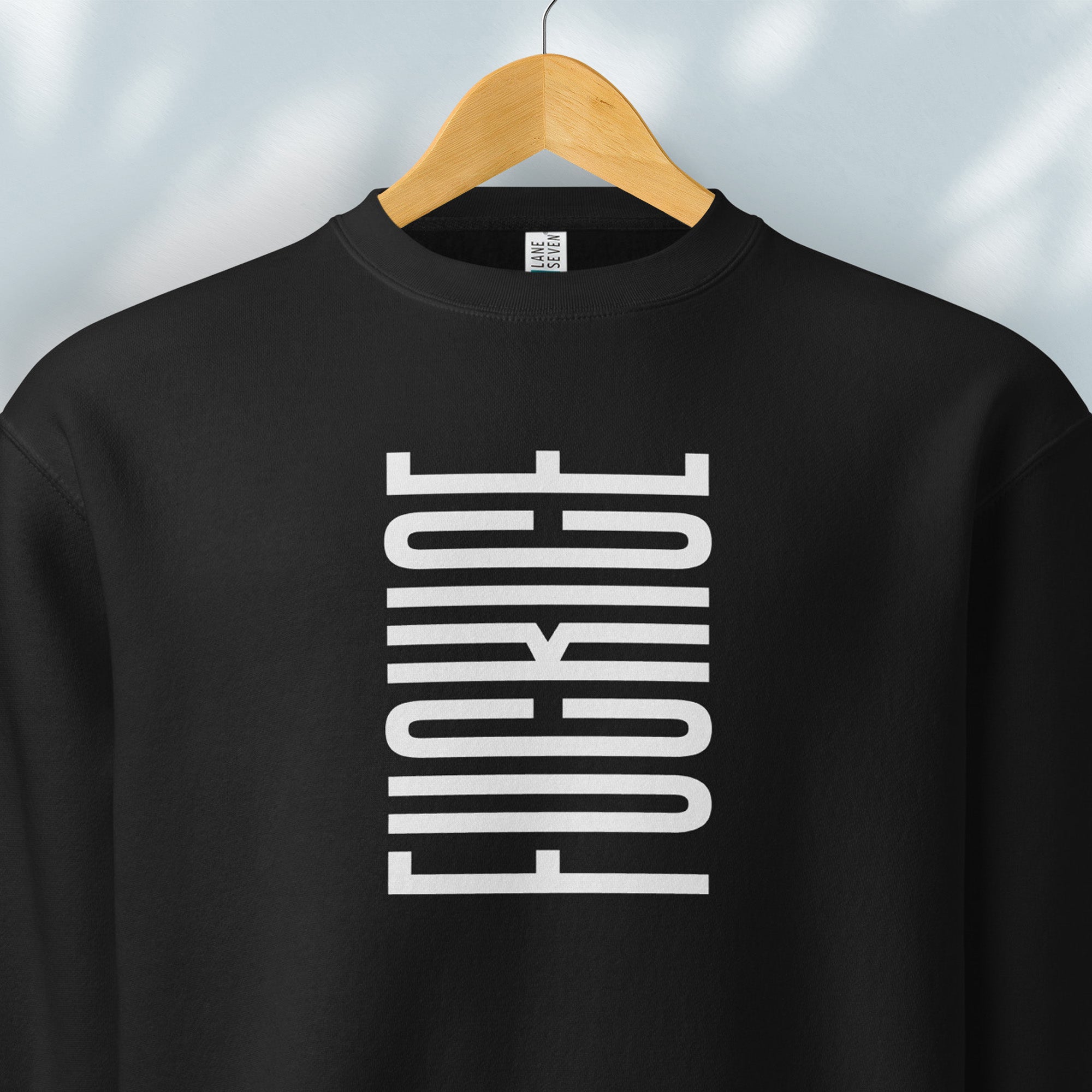 Hanging black sweatshirt with minimalist black geometric design that subtly spells “Fuck ICE” using stacked bars and negative space, hidden protest message shirt.