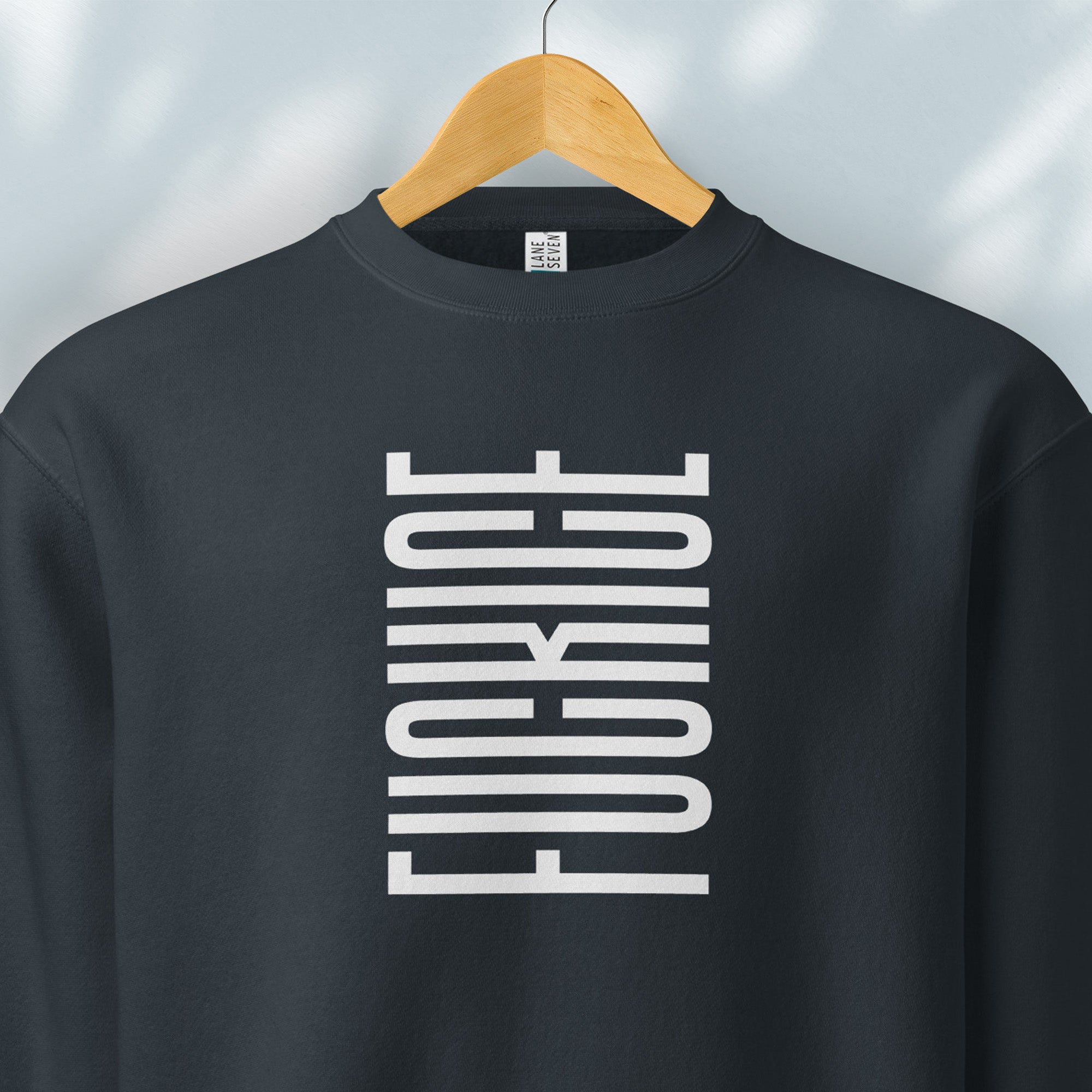 Hanging navy sweatshirt with minimalist black geometric design that subtly spells “Fuck ICE” using stacked bars and negative space, hidden protest message shirt.