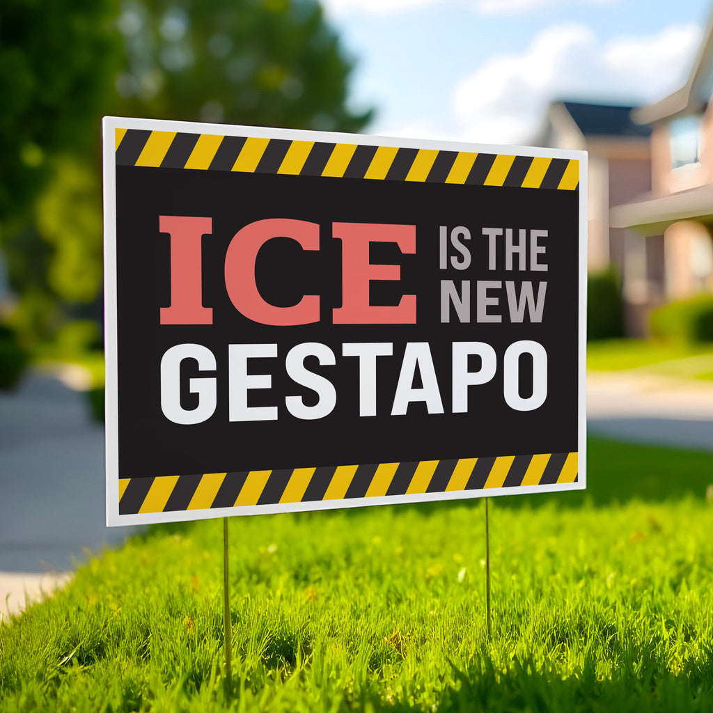 Yard sign in green lawn that reads "ICE is the new gestapo" in strong bold red, grey, and white text on a black background with yellow warning stripes at the top and bottom.