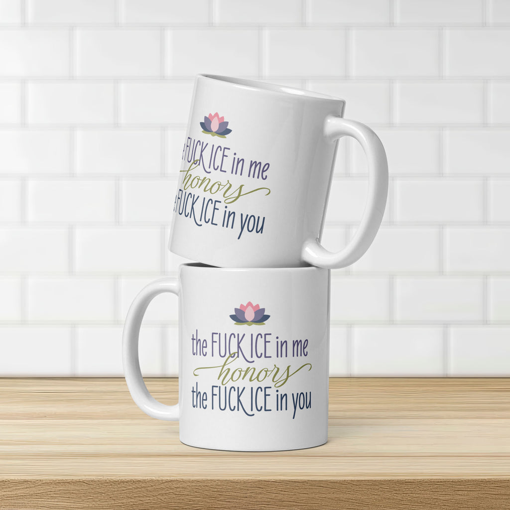 Two mugs featuring the phrase "The Fck ICE in Me Honors the Fck ICE in You", stacked on a kitchen counter, showing both sides of the mug.