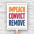 Anti-Trump protest sign reading “Impeach Convict Remove” in bold red, blue, and orange text with stars.
