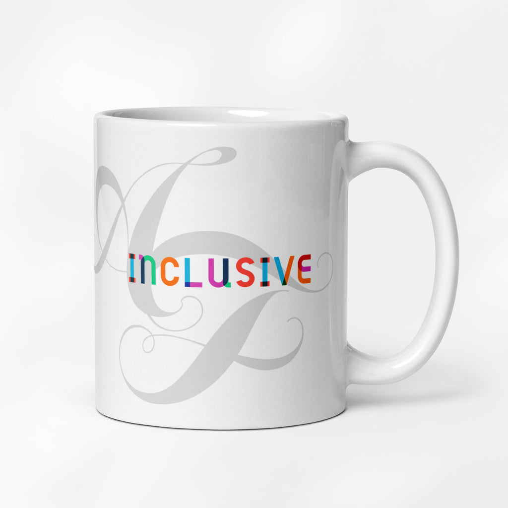 11 ounce white ceramic mug with the word “Inclusive” in colorful Gilbert font and faint script letters A and F behind it.