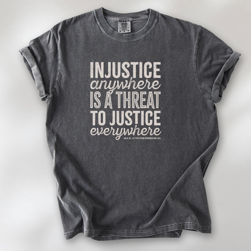 Pepper t-shirt with bold text reading “Injustice anywhere is a threat to justice everywhere” quote from Martin Luther King Jr, MLK Jr, Letter from Birmingham jail — civil rights protest apparel for activists.