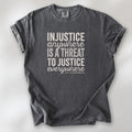 Pepper t-shirt with bold text reading “Injustice anywhere is a threat to justice everywhere” quote from Martin Luther King Jr, MLK Jr, Letter from Birmingham jail — civil rights protest apparel for activists.