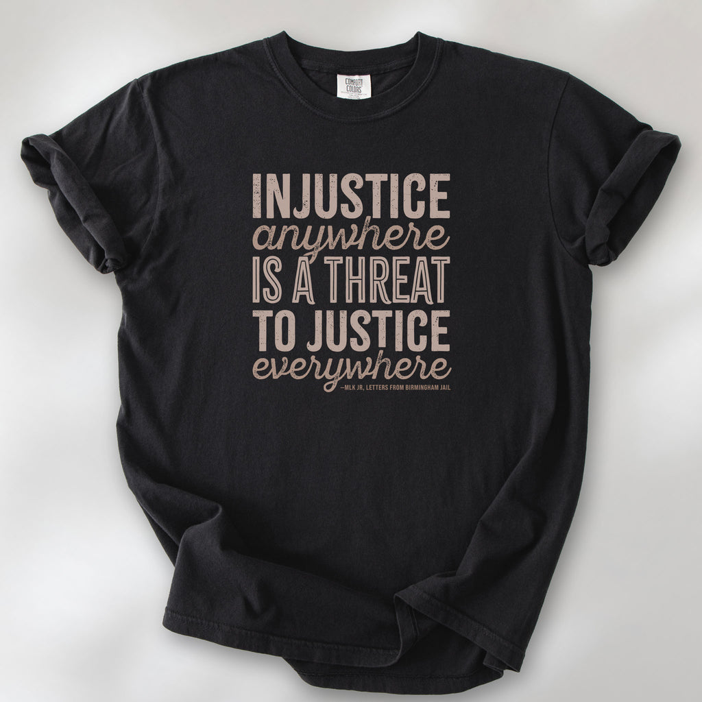 Black t-shirt with bold text reading “Injustice anywhere is a threat to justice everywhere” quote from Martin Luther King Jr, MLK Jr, Letters from Birmingham jail — civil rights protest apparel for activists.