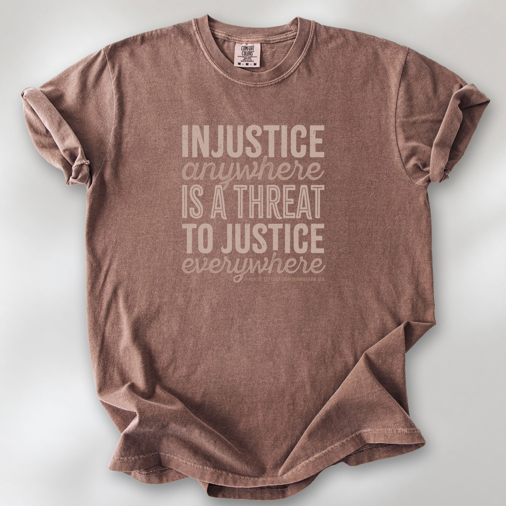 Espresso t-shirt with bold text reading “Injustice anywhere is a threat to justice everywhere” quote from Martin Luther King Jr, MLK Jr, Letters from Birmingham jail — civil rights protest apparel for activists.