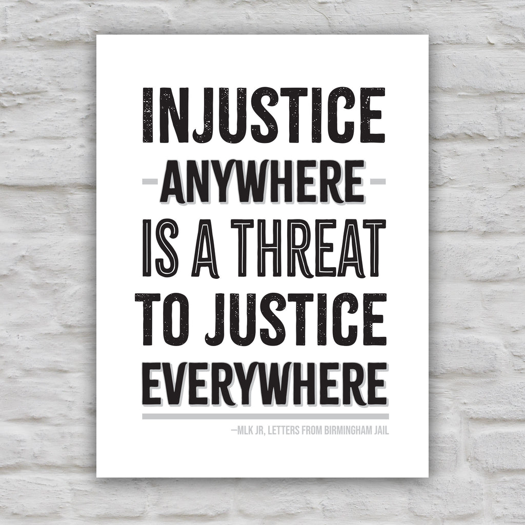 Black and white version of protest sign with quote from Martin Luther King Jr that reads "injustice anywhere is a threat to justice everywhere" in bold black distressed text.