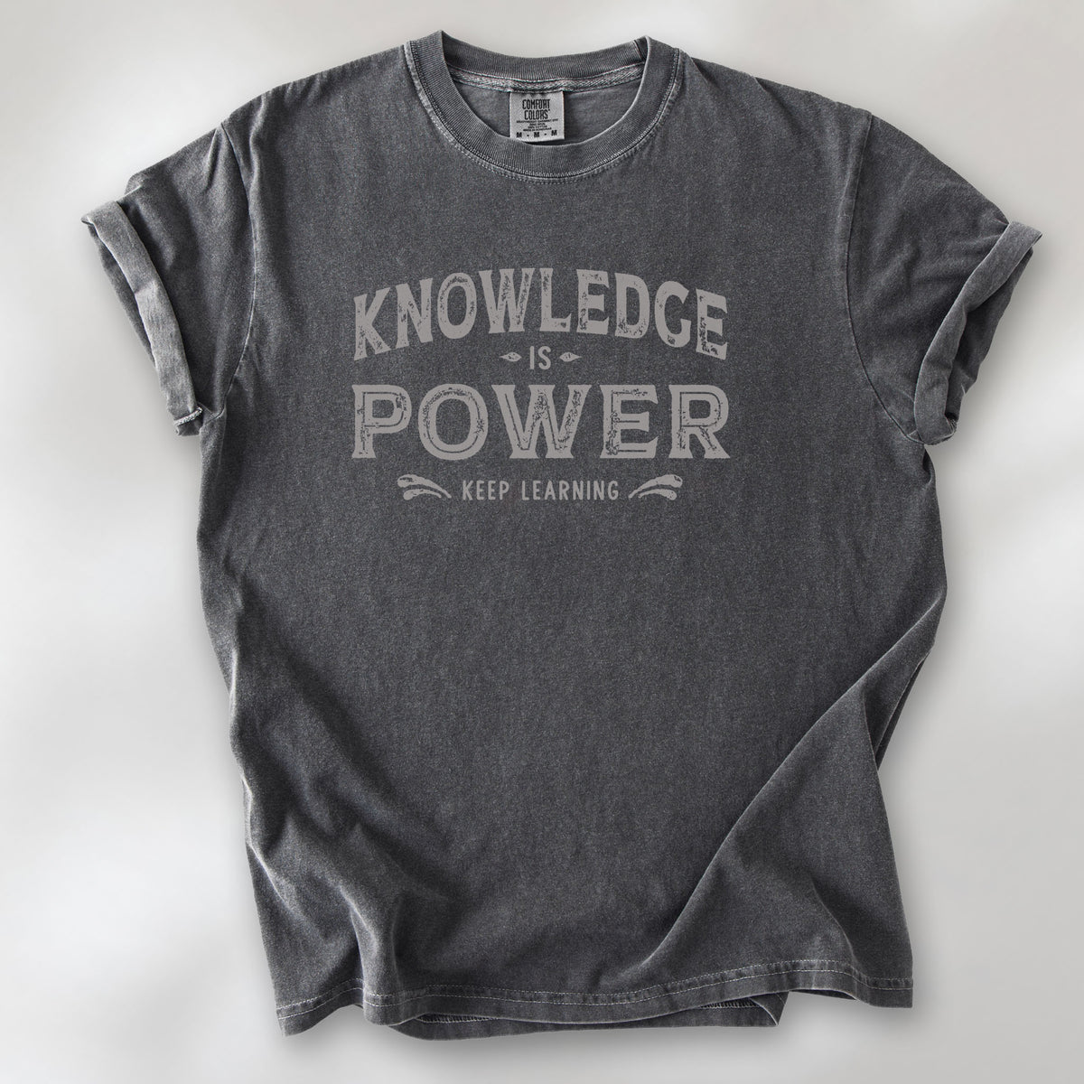 Pepper t-shirt with vintage style typography reading “Knowledge Is Power – Keep Learning."