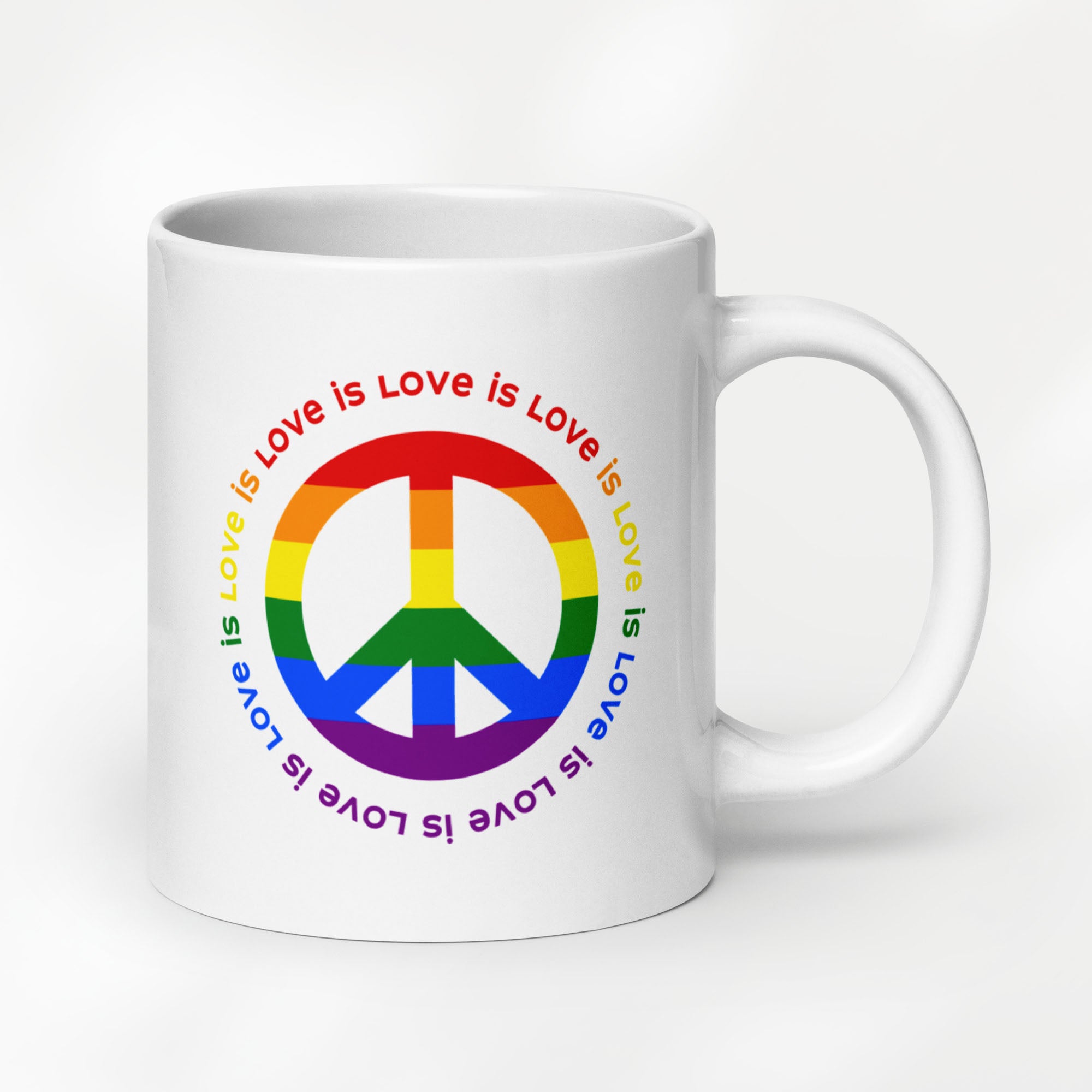 20 ounce white ceramic coffee mug with a peace sign in the colors of the LGBTQ+ flag, surrounded by repeated "love is love" text. 