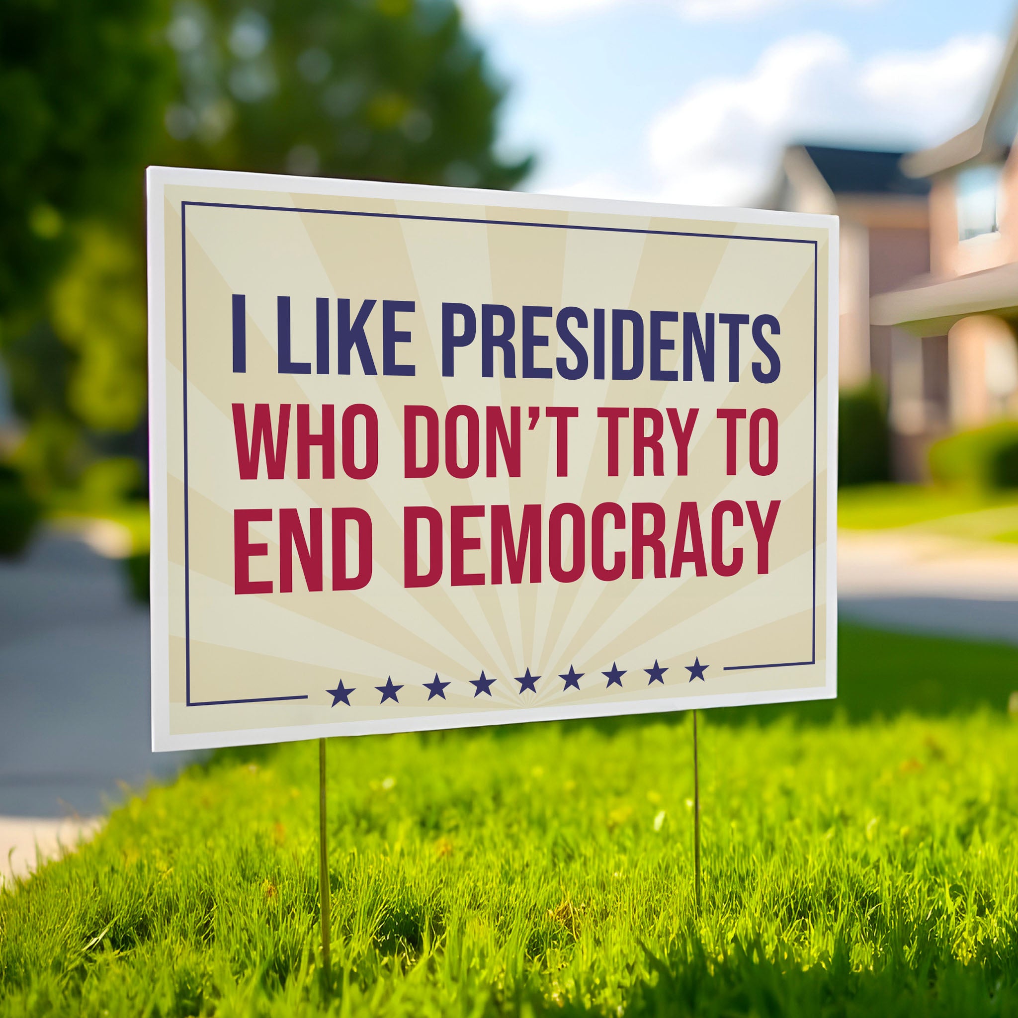 Yard sign with light gold background and red and blue bold text that reads "I like presidents who don't try to end democracy."