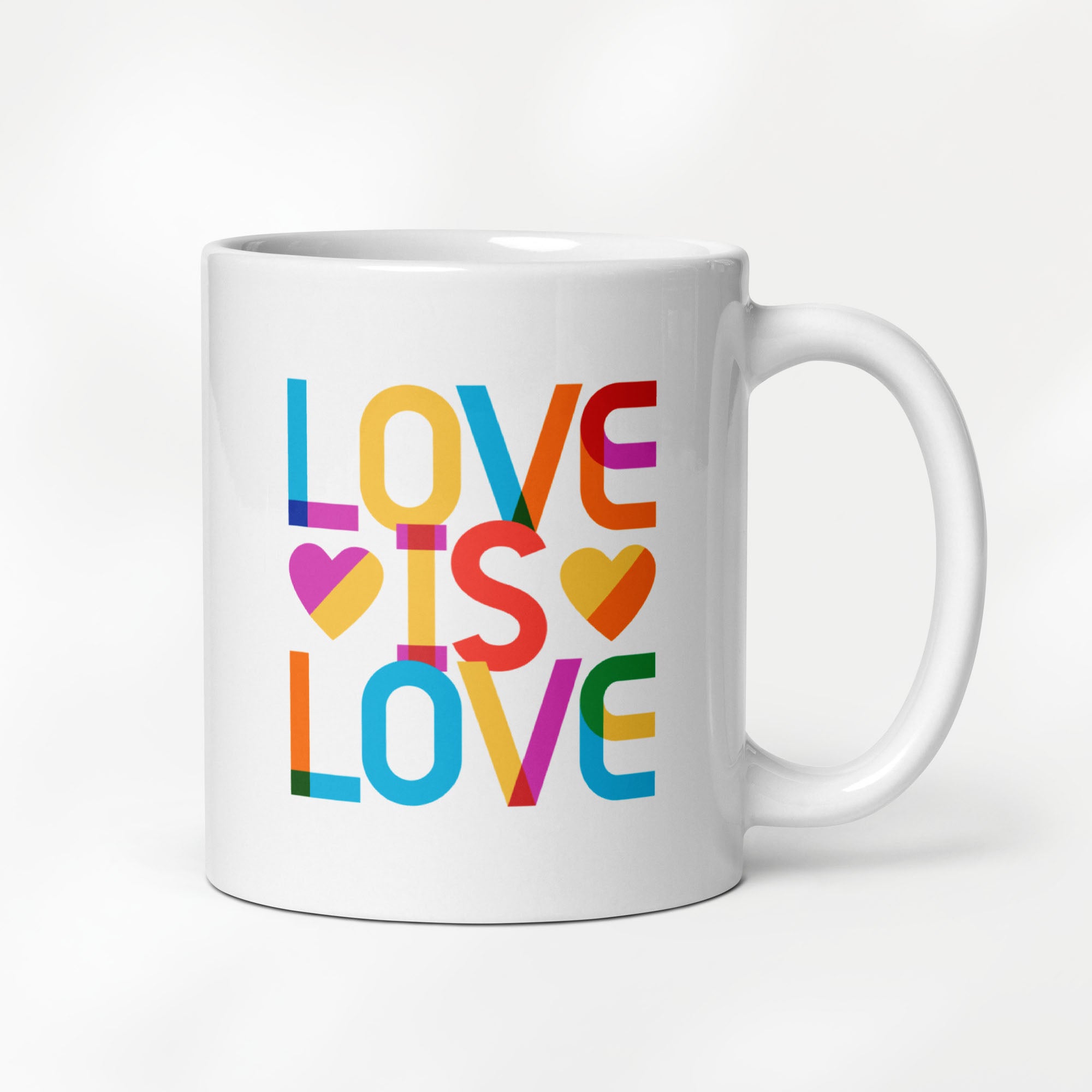 11 ounce white ceramic coffee mug with rainbow “love is love” text in a block design.