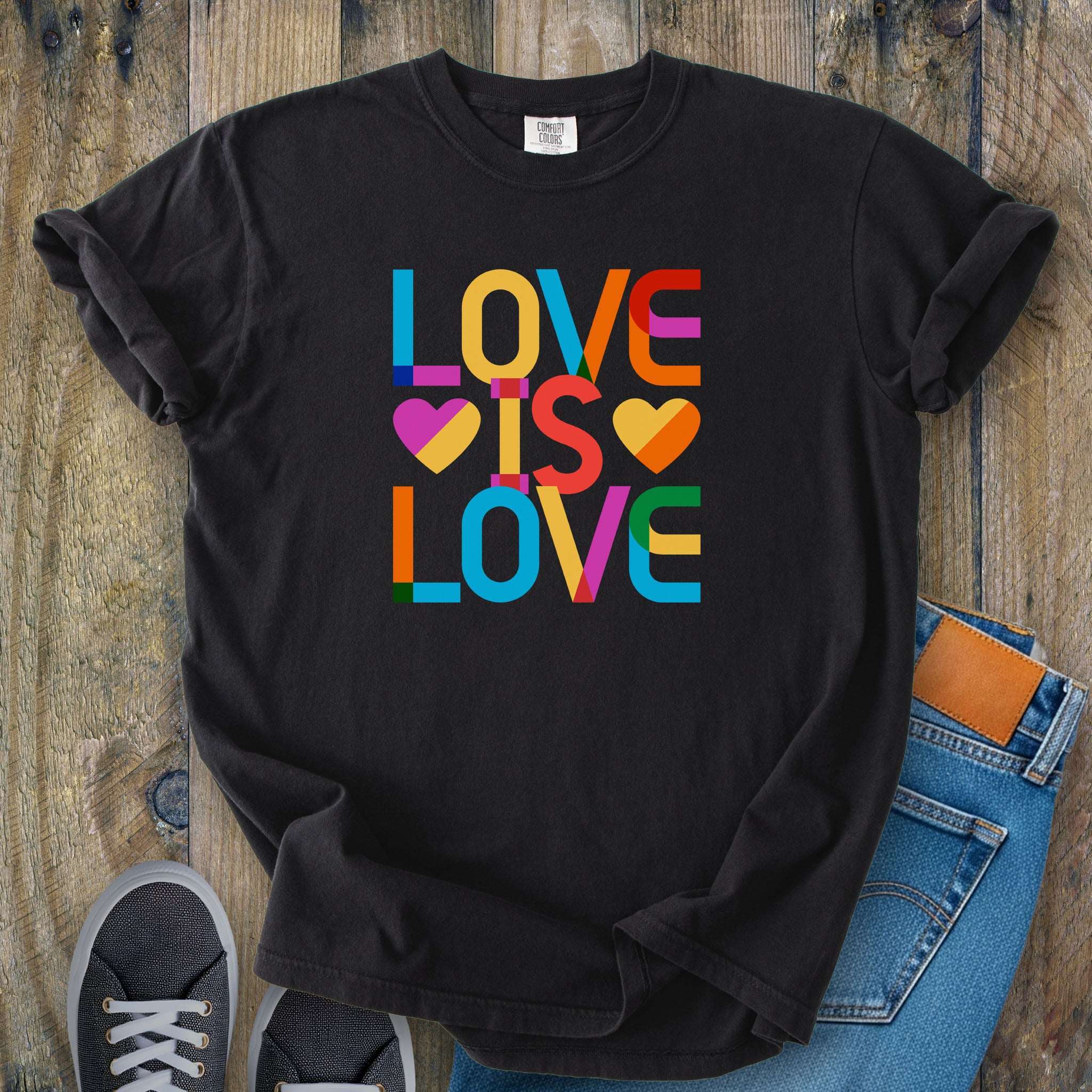 Black t-shirt with rainbow “love is love” text designed in the Gilbert font.