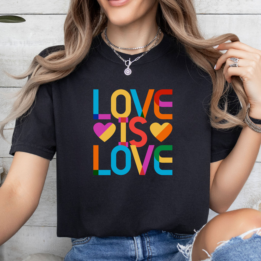 Female model wearing black t-shirt with rainbow “love is love” text designed in the Gilbert font.