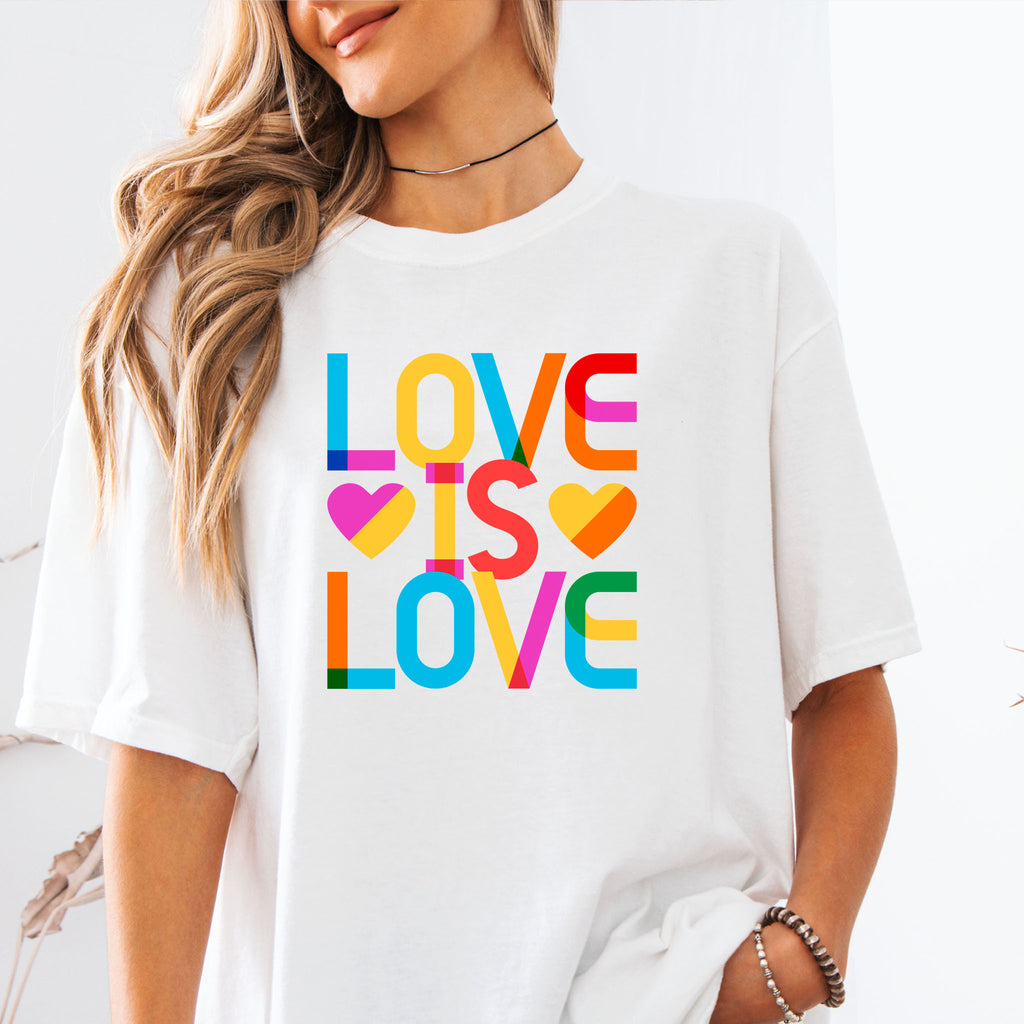 Female model wearing white t-shirt with rainbow “love is love” text designed in the Gilbert font.