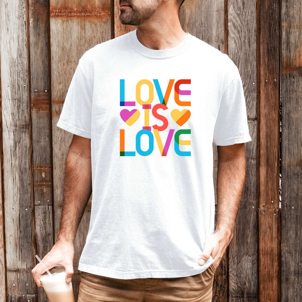 Male model wearing white t-shirt with rainbow “love is love” text designed in the Gilbert font.