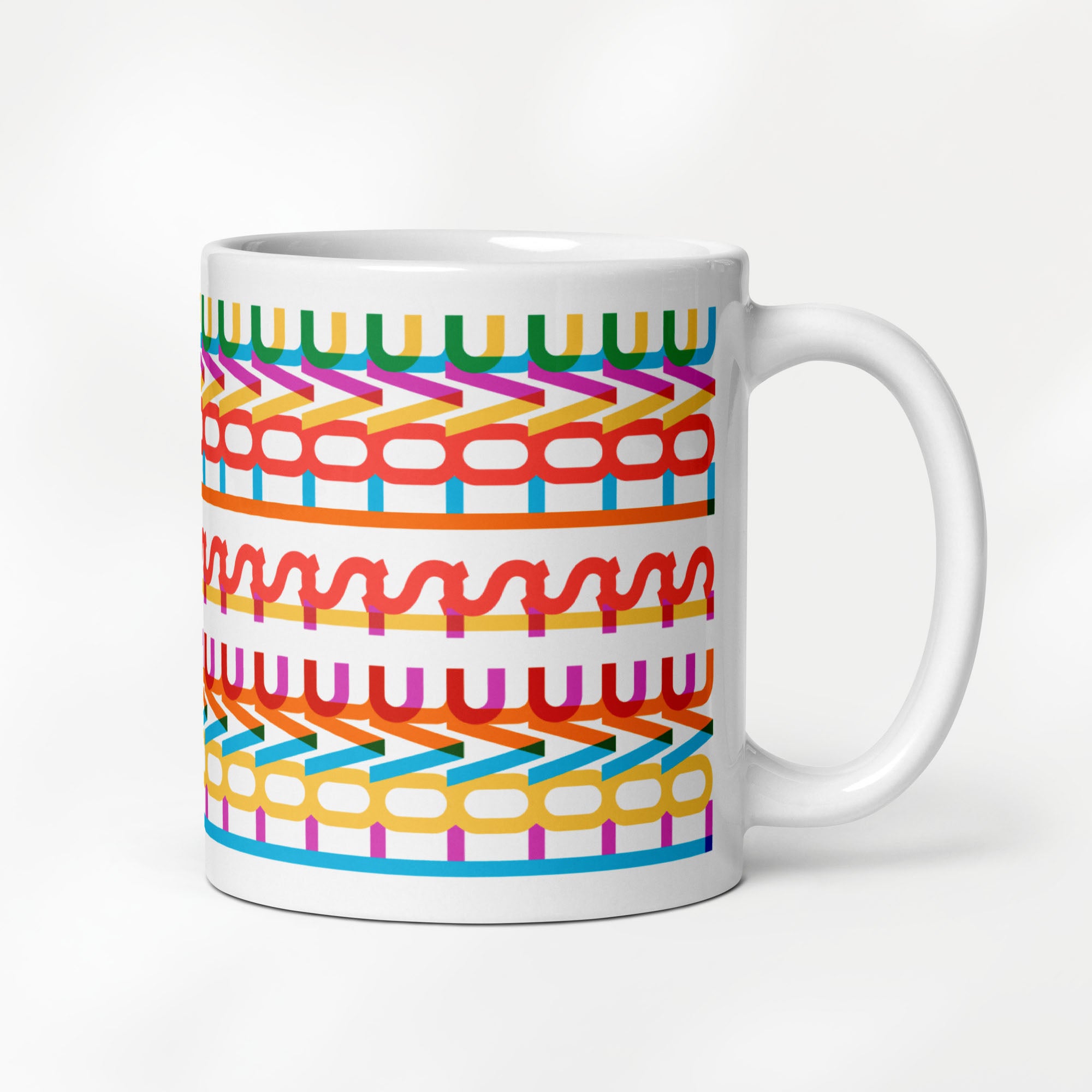 11 ournce coffee mug with a repeating hidden “love is love” message in the Gilbert font, featuring bright rainbow-inspired patterns wrapped around the mug.