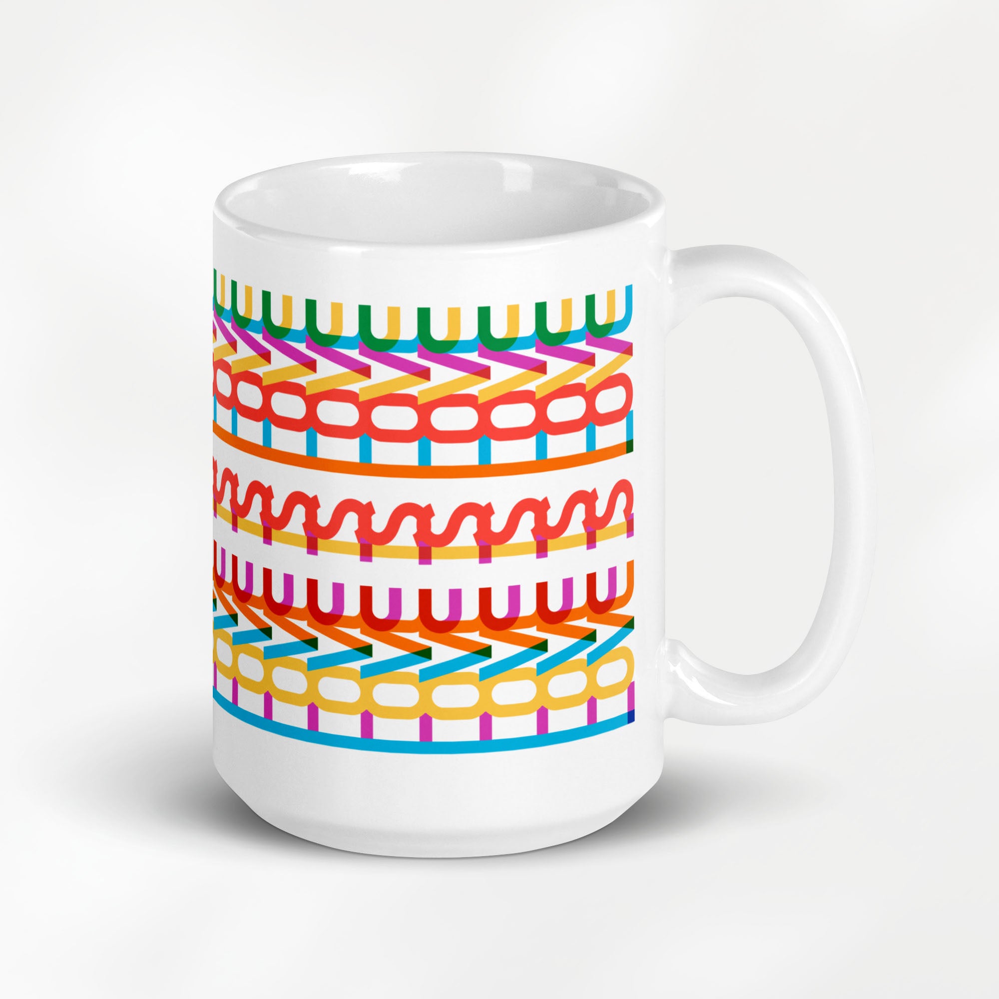 15 ournce coffee mug with a repeating hidden “love is love” message in the Gilbert font, featuring bright rainbow-inspired patterns wrapped around the mug.