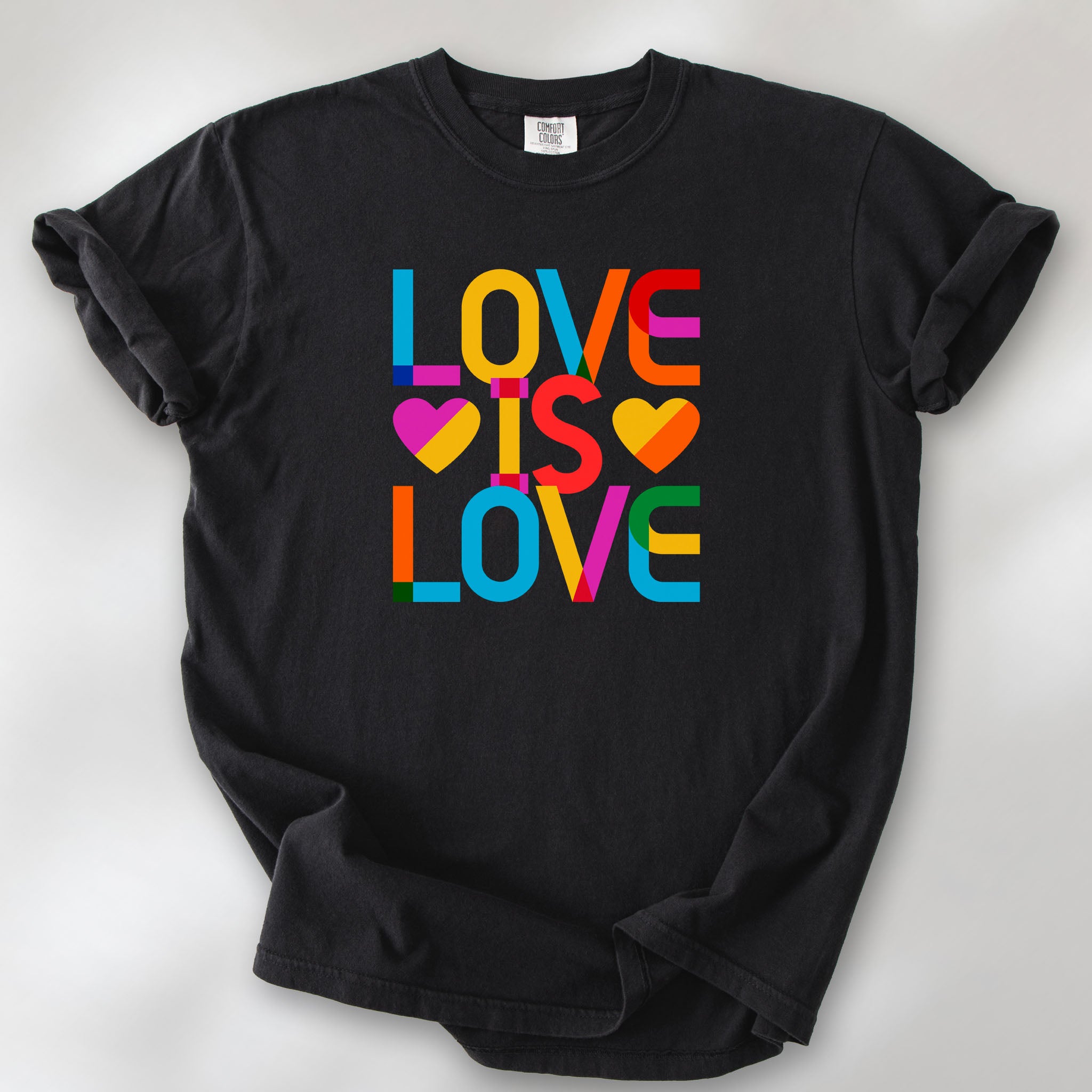 Black t-shirt with rainbow “love is love” text block.