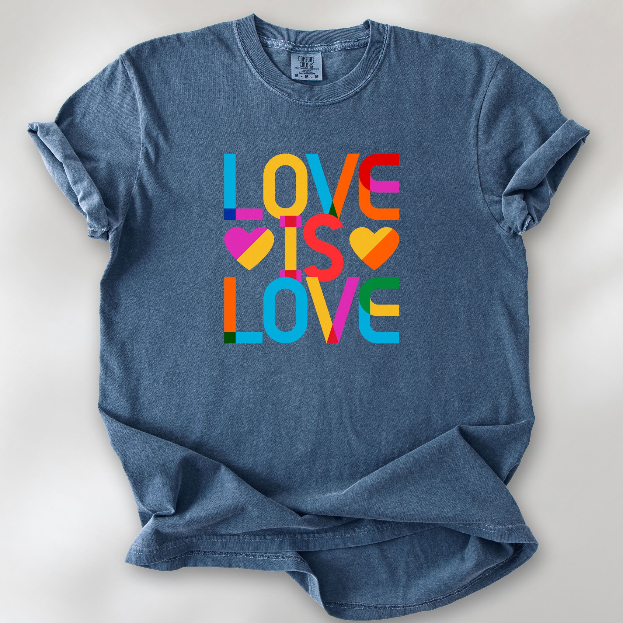 Denim t-shirt with rainbow “love is love” text block.