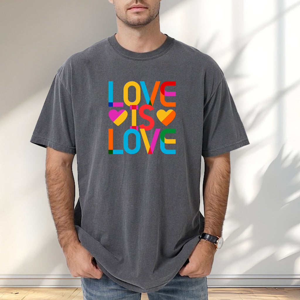 Male model wearing pepper t-shirt with rainbow “love is love” text block.