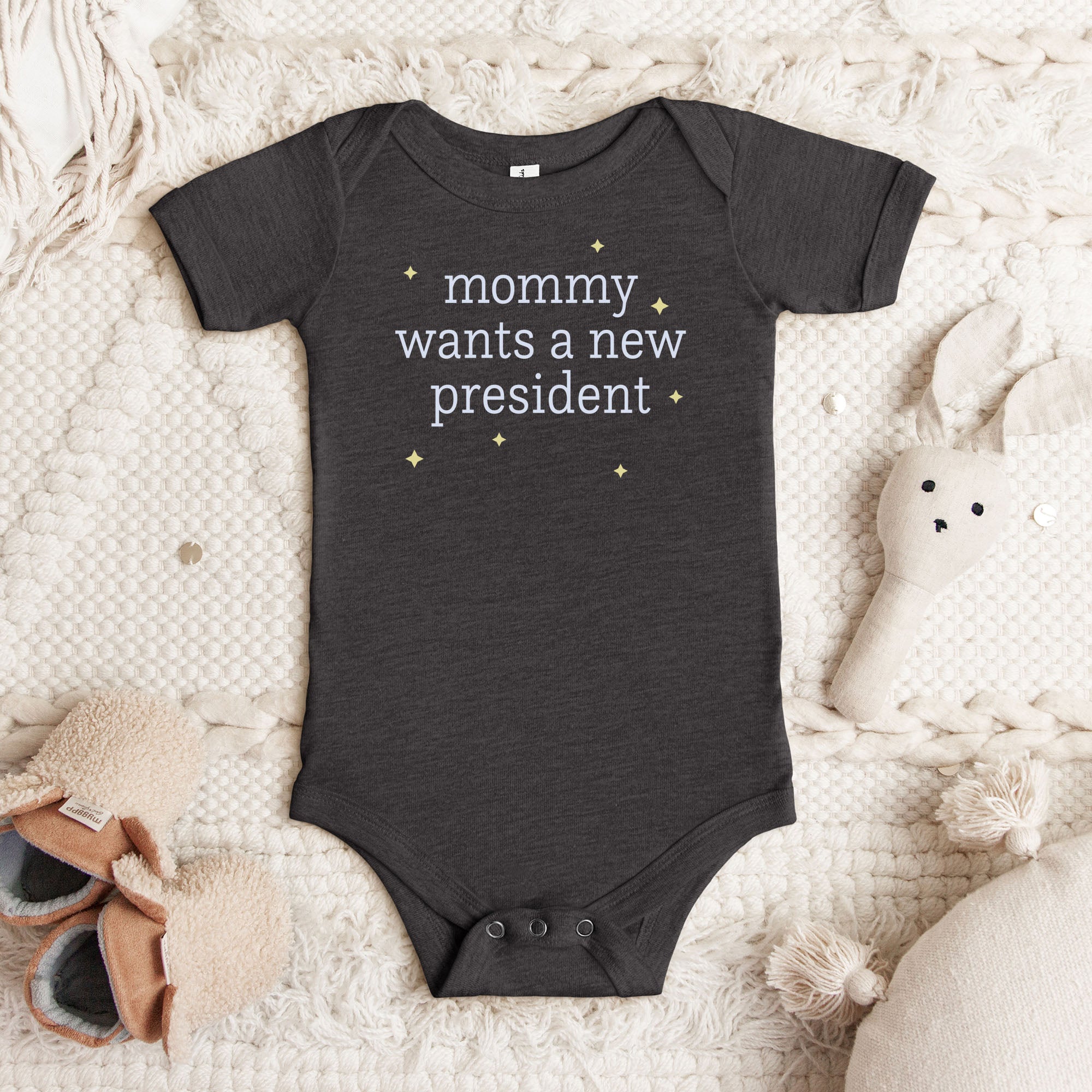 Dark grey heather baby short sleeve one piece with light text reading “mommy wants a new president."